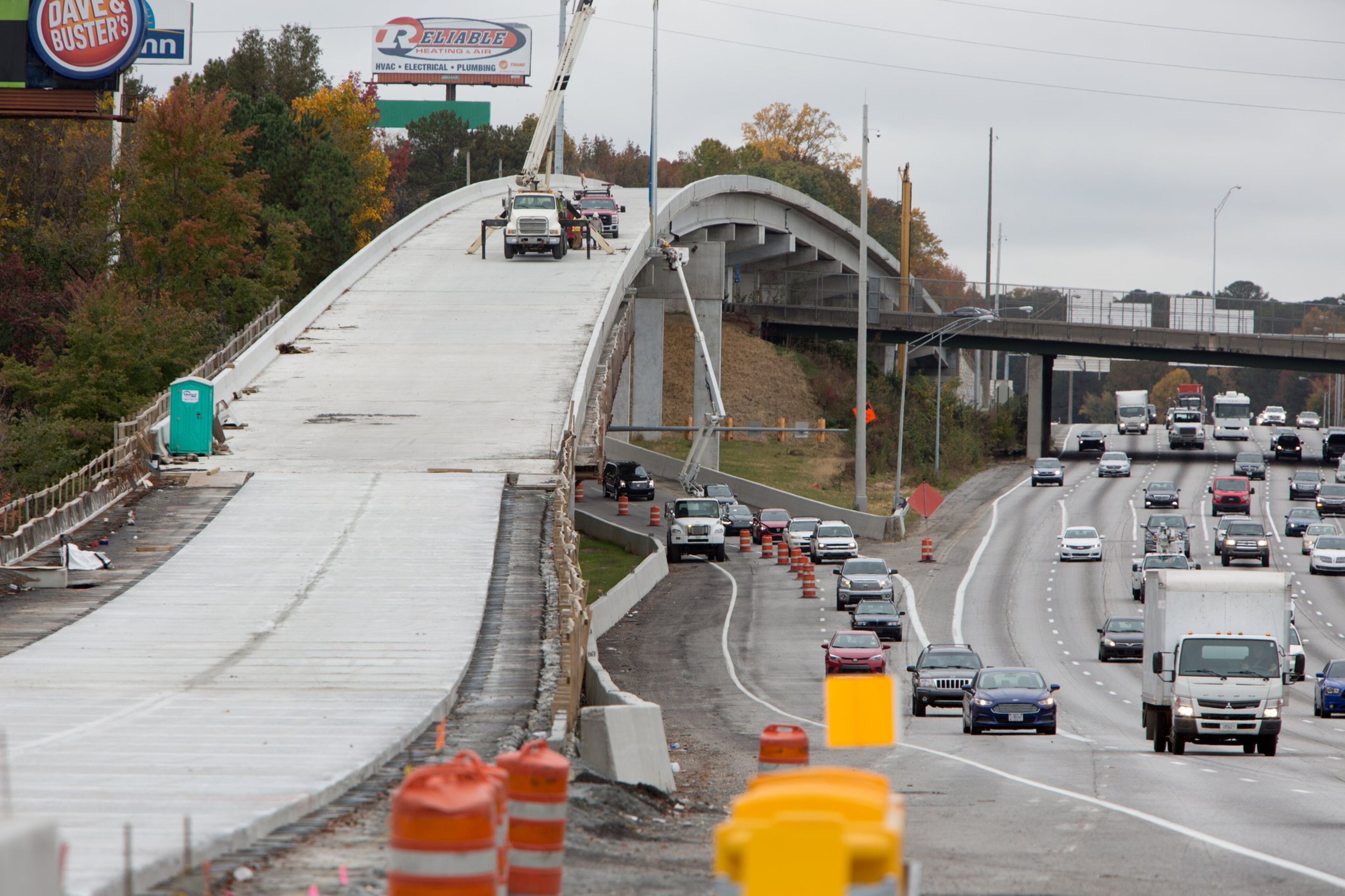 Workers prepare part of a bridge near Delk Road, part of the new Northwest Corridor Express Lanes. (Photo by Phil Skinner)