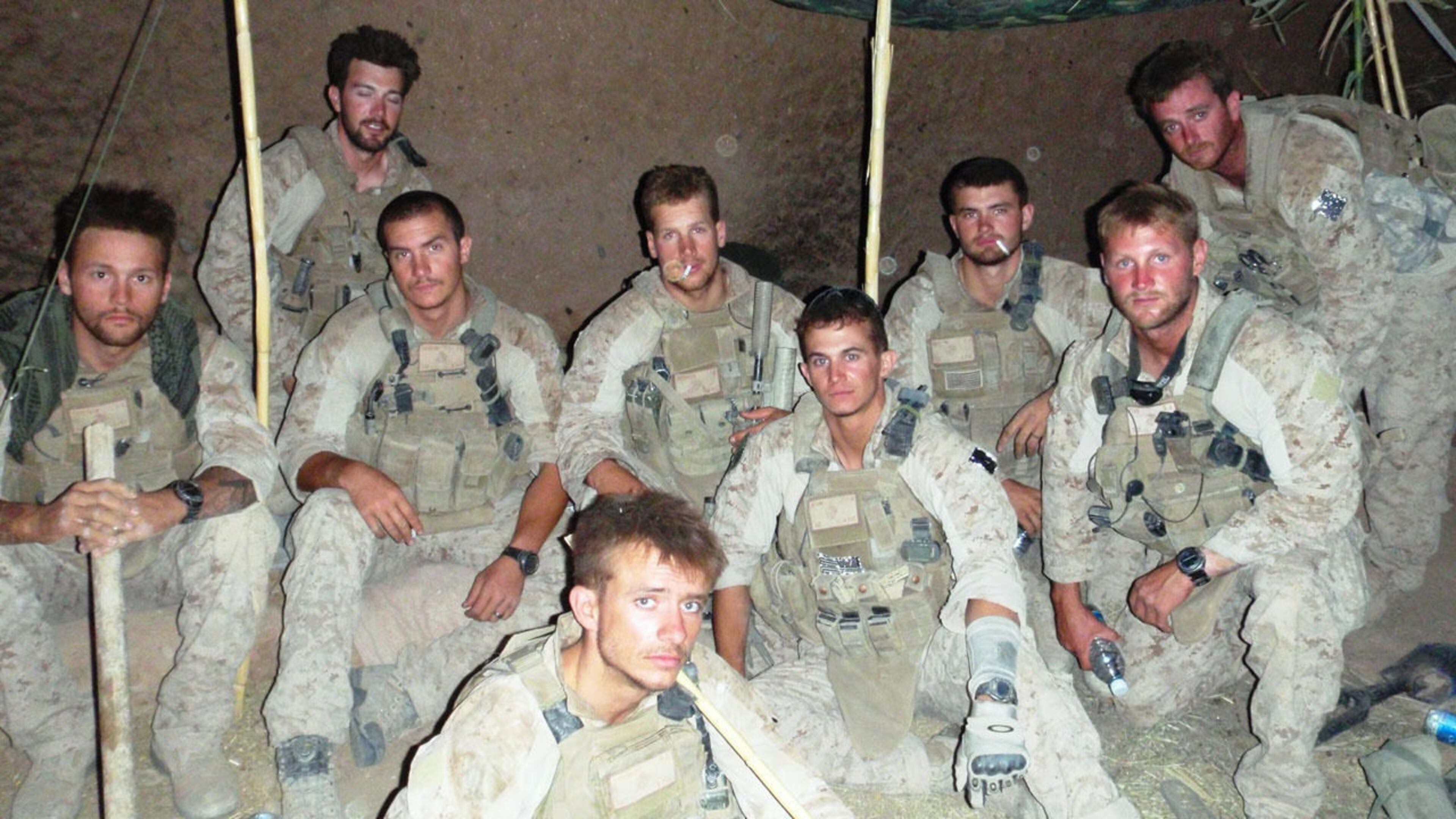 FILE PHOTO: U.S. Marines pose for a photo in Helmand province, Afghanistan, in June of 2010. Two members of the division recently hiked a mountain despite one of them losing both legs to an improvised explosive device.