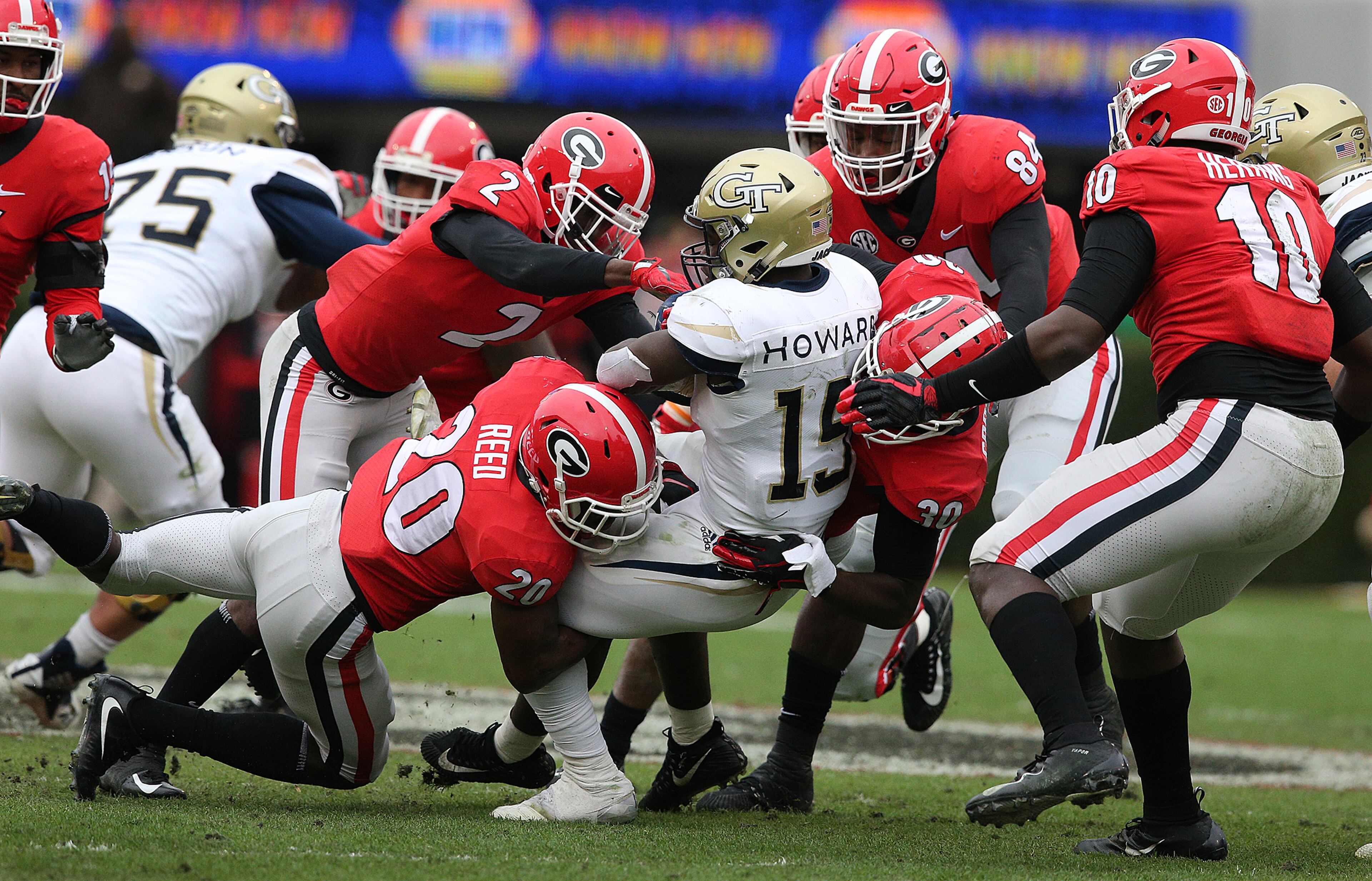 Nov 24, 2018 Athens: Georgia defenders gang tackle Georgia Tech runner Jerry Howard for a loss during the first half in their NCAA college football rivalry game on Saturday, Nov. 24, 2018, in Athens. Curtis Compton/ccompton@ajc.com