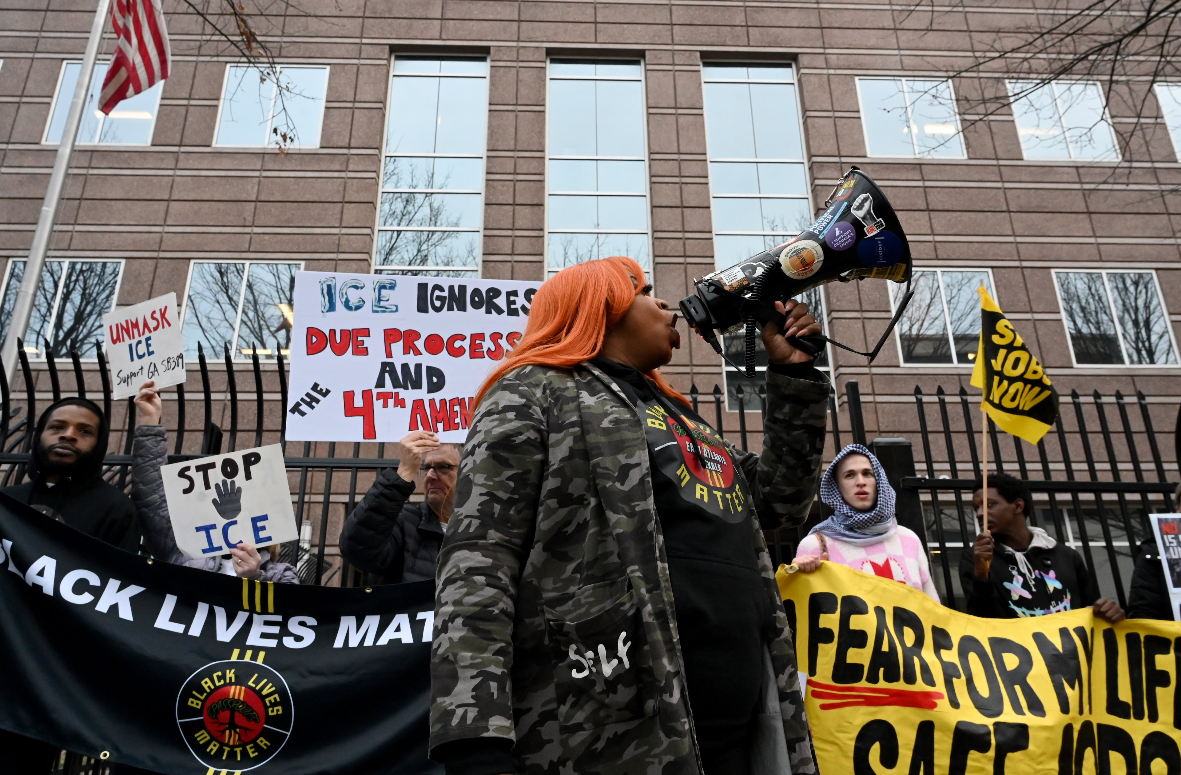 Protesters gather to protest federal agents presence in Minnesota outside ICE’s Atlanta Field Office, Friday, Jan. 23, 2026, in Atlanta. (Hyosub Shin/AJC)