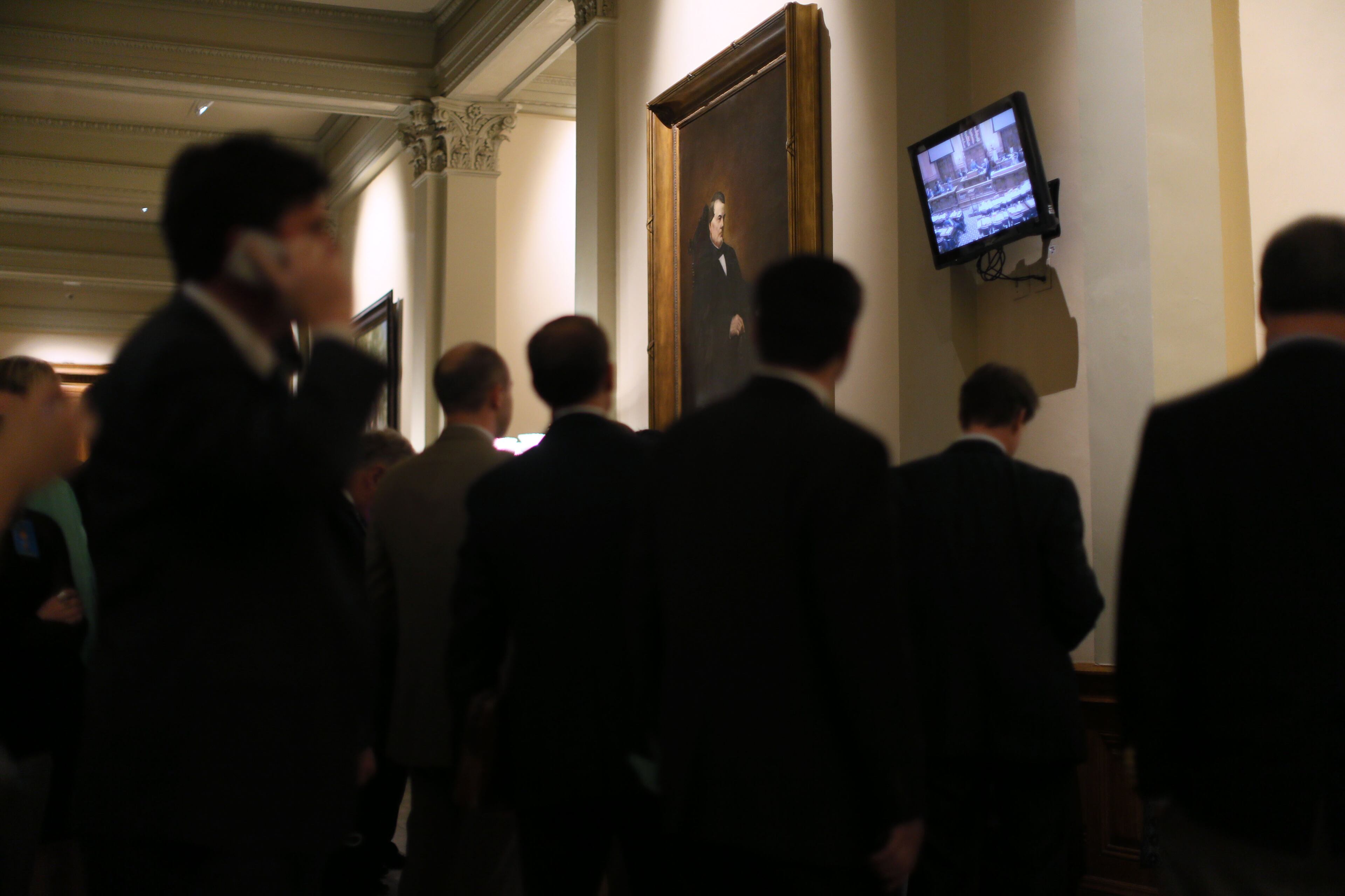 Mar. 24, 2016 - Atlanta - Lobbyists watch the action on a monitor out in the hall. As this years general assembly comes to a close on the 40th day of the legislative session, legislators must consider scores of bills before the midnight deadline. BOB ANDRES / BANDRES@AJC.COM