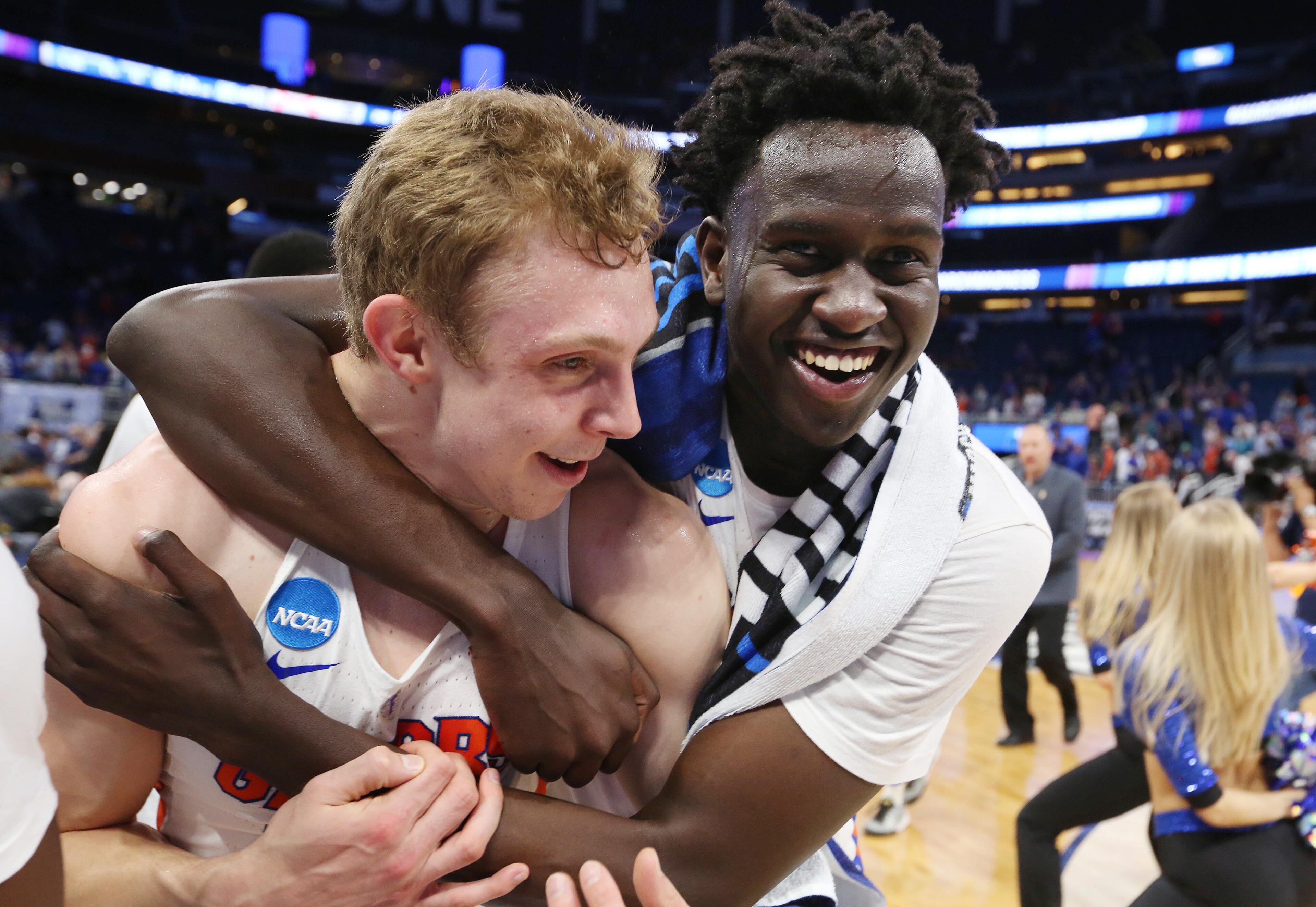 Florida players Canyon Barry (left) and Gorjok Gak celebrate after Gators' big win over Virginia Saturday.