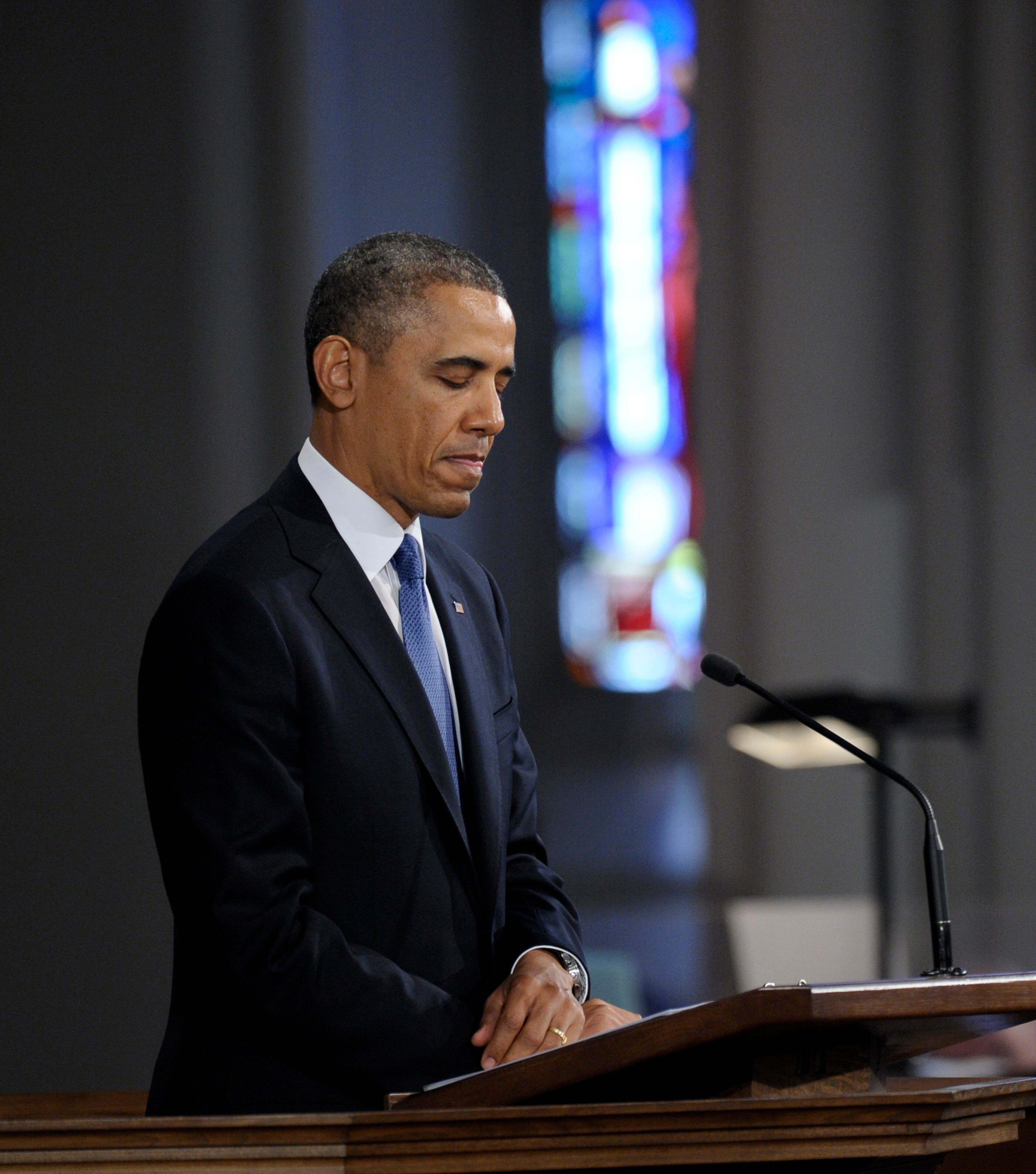 President Barack Obama pauses while speaking at the "Healing Our City: An Interfaith Service" at the Cathedral of the Holy Cross in Boston.
