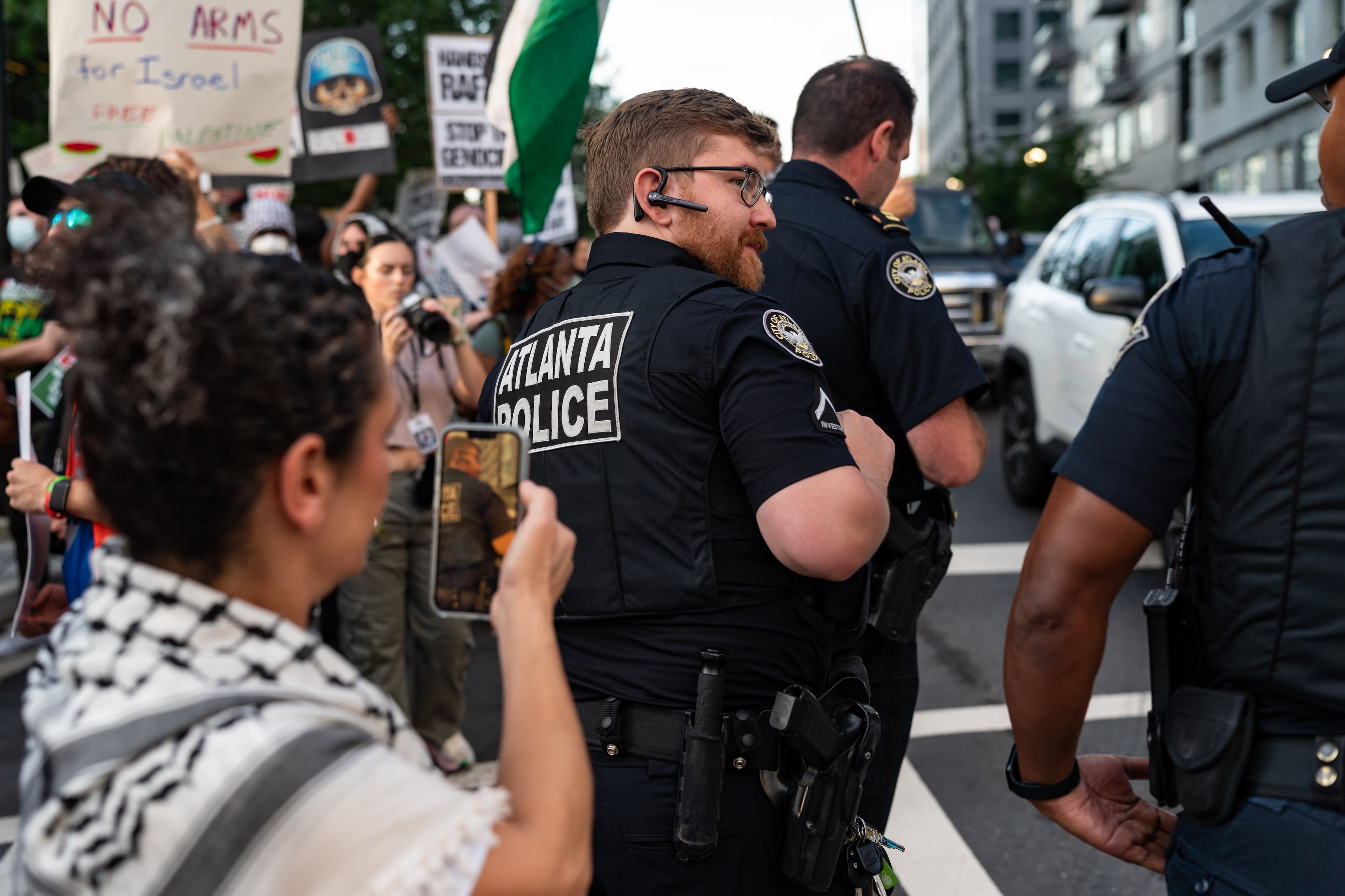 Police stand between traffic and a pro-Palestinian protest near the intersection of 10th Street NW and Spring Street NW in Atlanta on Thursday, June 27, 2024. Nearby, President Joe Biden and former President Donald Trump participated in a debate hosted by CNN. (Seeger Gray / AJC)