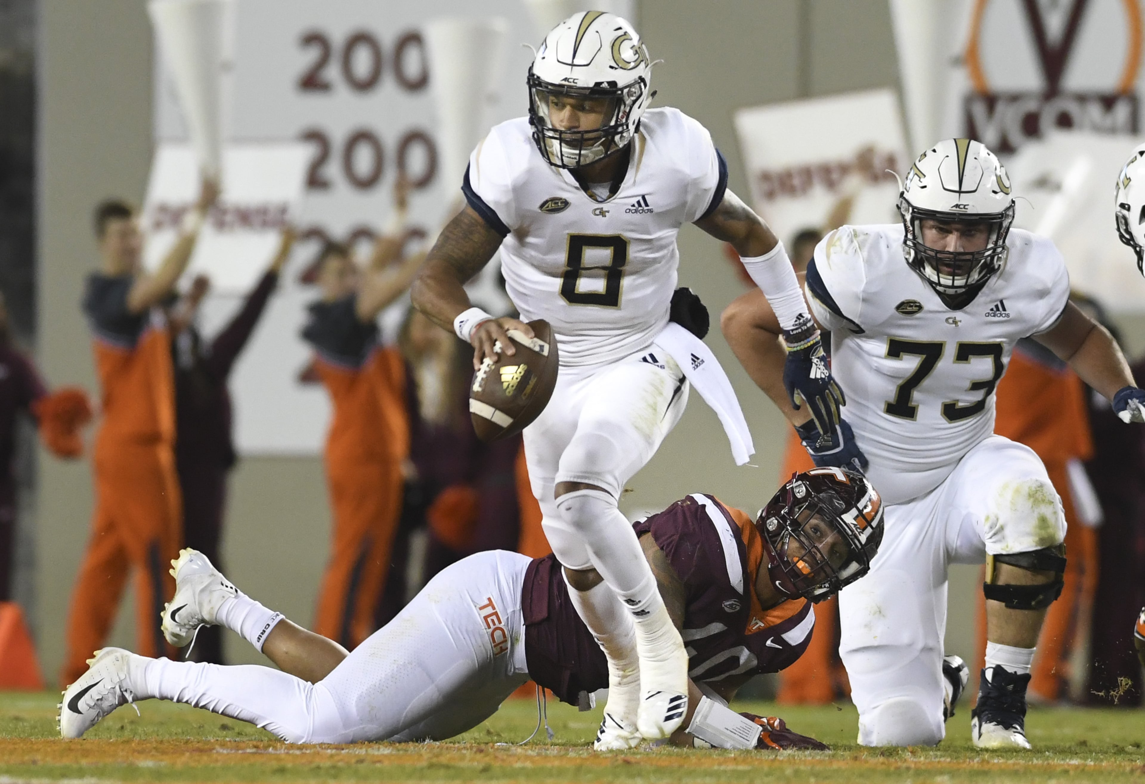 BLACKSBURG, VA - OCTOBER 25: Quarterback Tobias Oliver #8 of the Georgia Tech Yellow Jackets avoids the tackle of defensive lineman Emmanuel Belmar #40 of the Virginia Tech Hokies in the first half at Lane Stadium on October 25, 2018 in Blacksburg, Virginia. (Photo by Michael Shroyer/Getty Images)