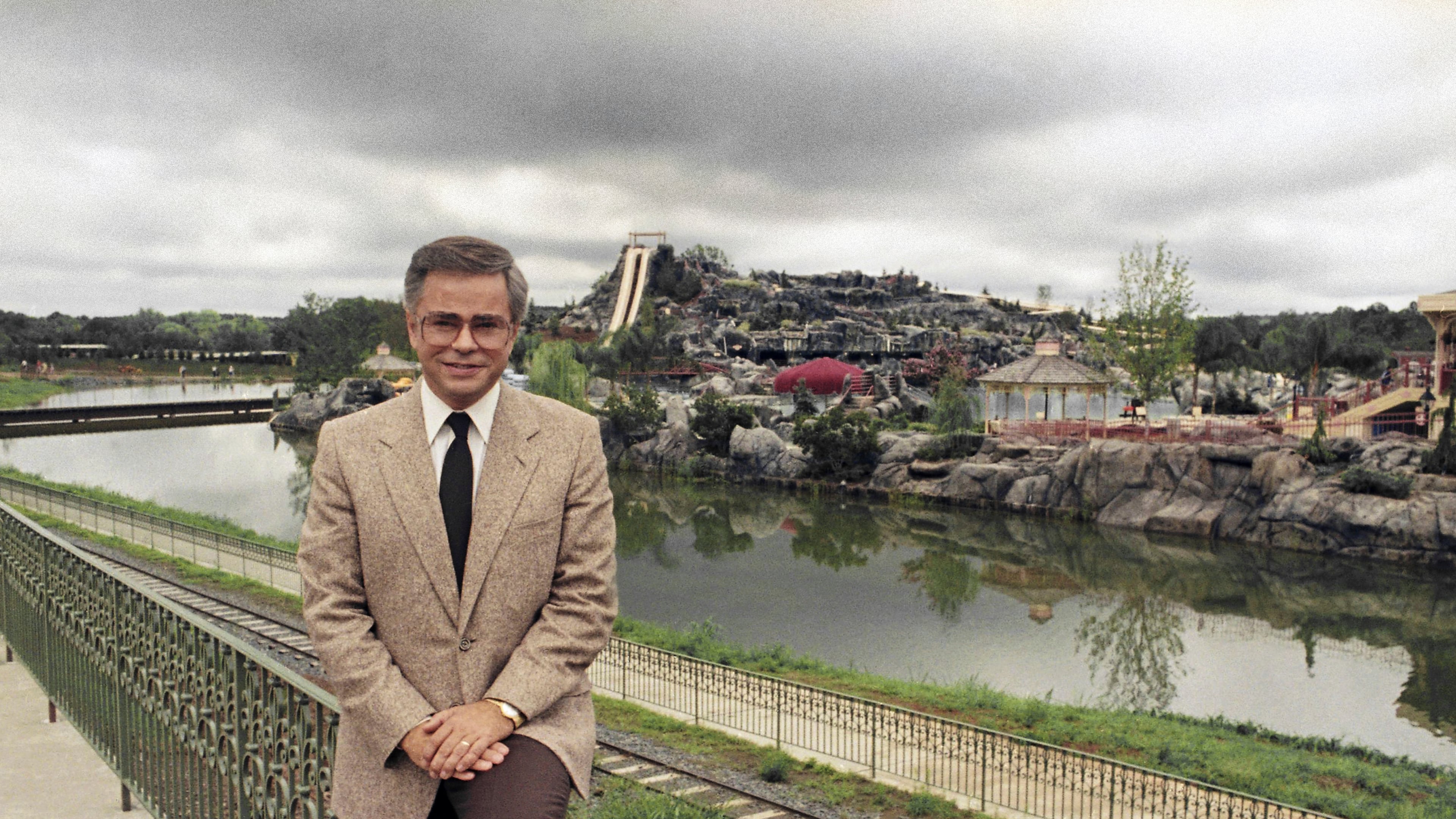 FILE - Television evangelist Jim Bakker poses in front of the Water Park in Columbia, SC, one of the attractions at his Heritage USA, March 19, 1987. (AP Photo/Lou Krasky, File)