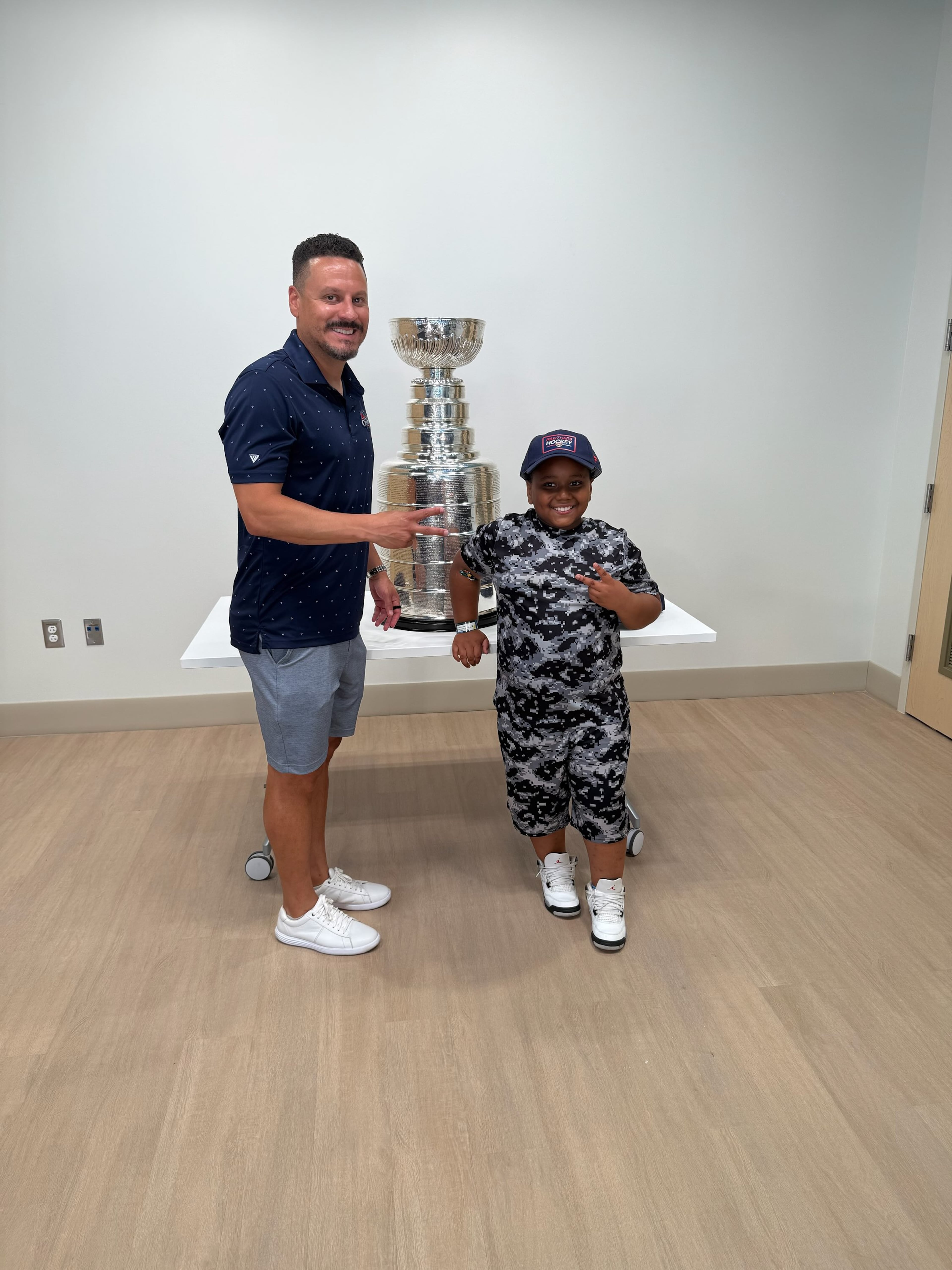 Huff poses with a patient alongside the Stanley Cup at Children’s Healthcare of Atlanta on July 15, 2025 at Arthur M. Blank Hospital in Atlanta. “I wanted to do something for those kids,” he said. (Courtesy of Mike Huff)