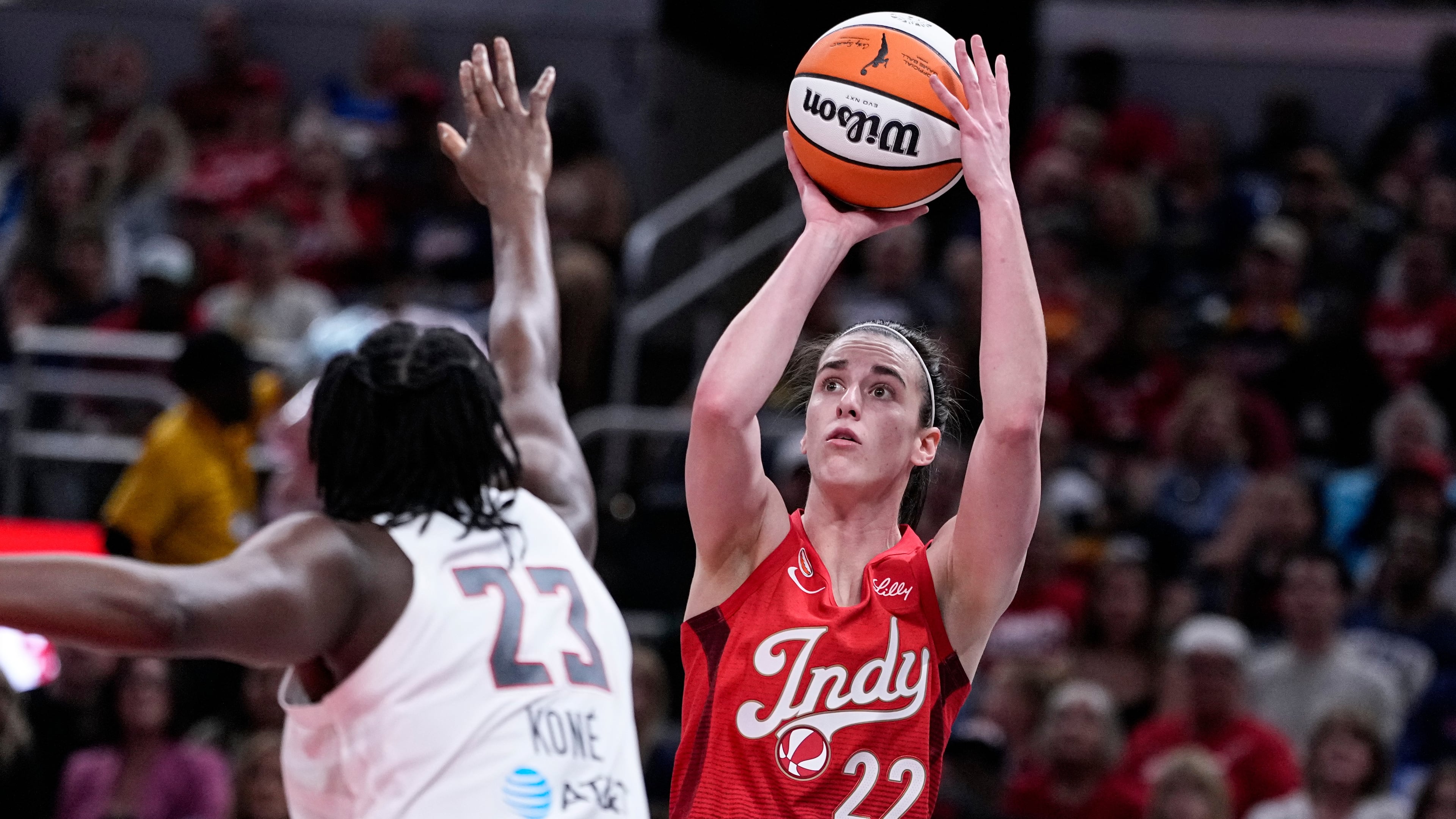 Indiana Fever guard Caitlin Clark (22) shoots over Atlanta Dream forward Sika Kone (23) in the first half of a WNBA basketball game in Indianapolis, Thursday, June 18, 2026. (AP Photo/Michael Conroy)