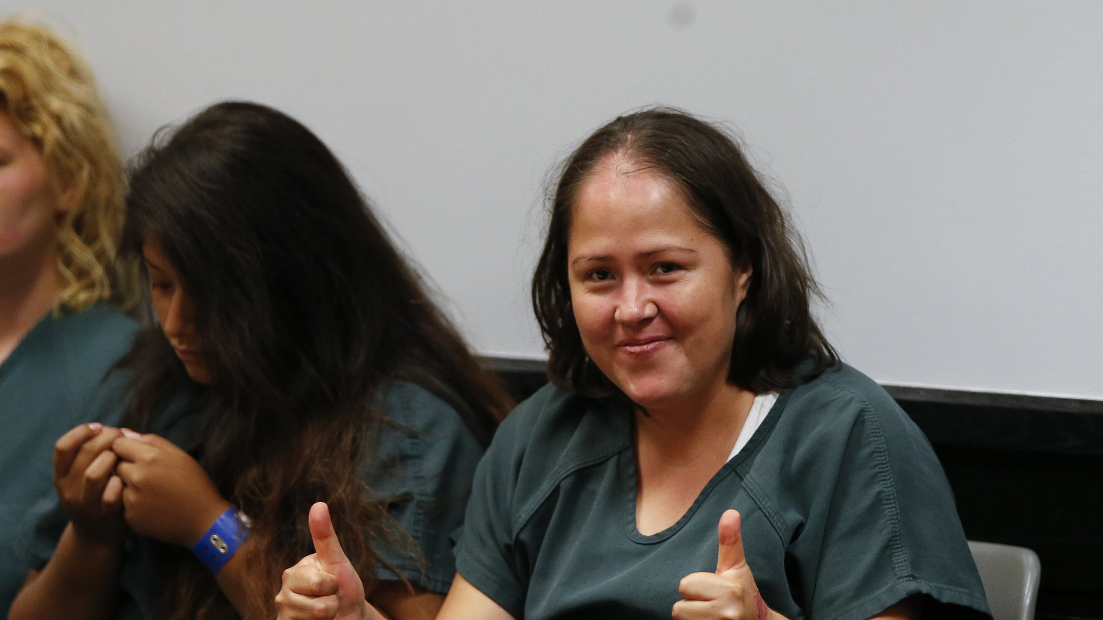 Isabel Martinez gestures towards news cameras during her first court appearance Friday, July 7, 2017, in Lawrenceville , Ga. Martinez is charged with killing four of her children and their father. (AP Photo/John Bazemore)