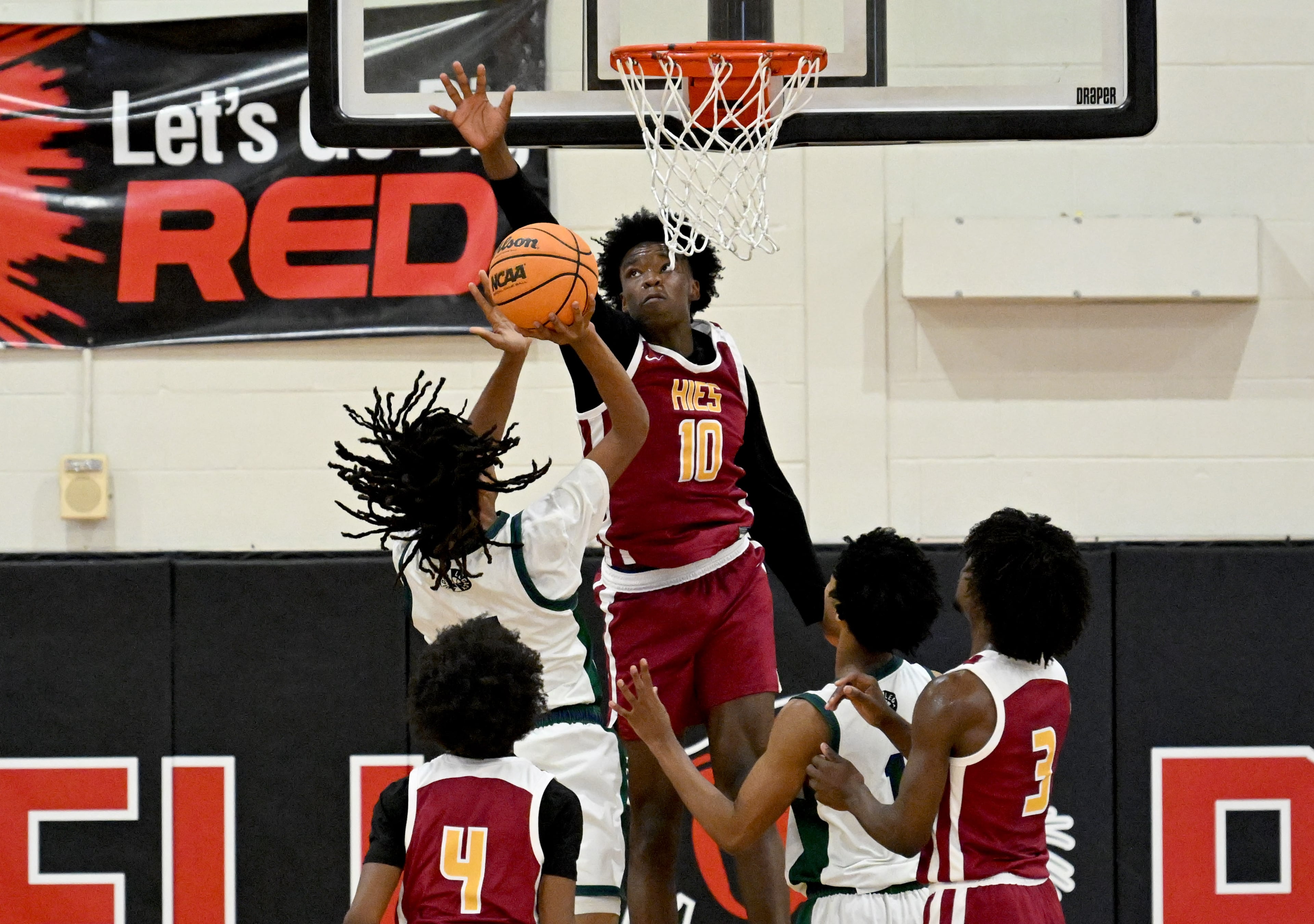 Holy Innocents Episcopal Khalid Worthy (10) knocks the ball away from KIPP Atlanta Collegiate Laqwaun Morgan (4) during Region 5AA Championship game at Therrell High School, Thursday, Feb. 19, 2026, in Atlanta. Holy Innocents Episcopal won 56-46 over KIPP Atlanta Collegiate. (Hyosub Shin/AJC)