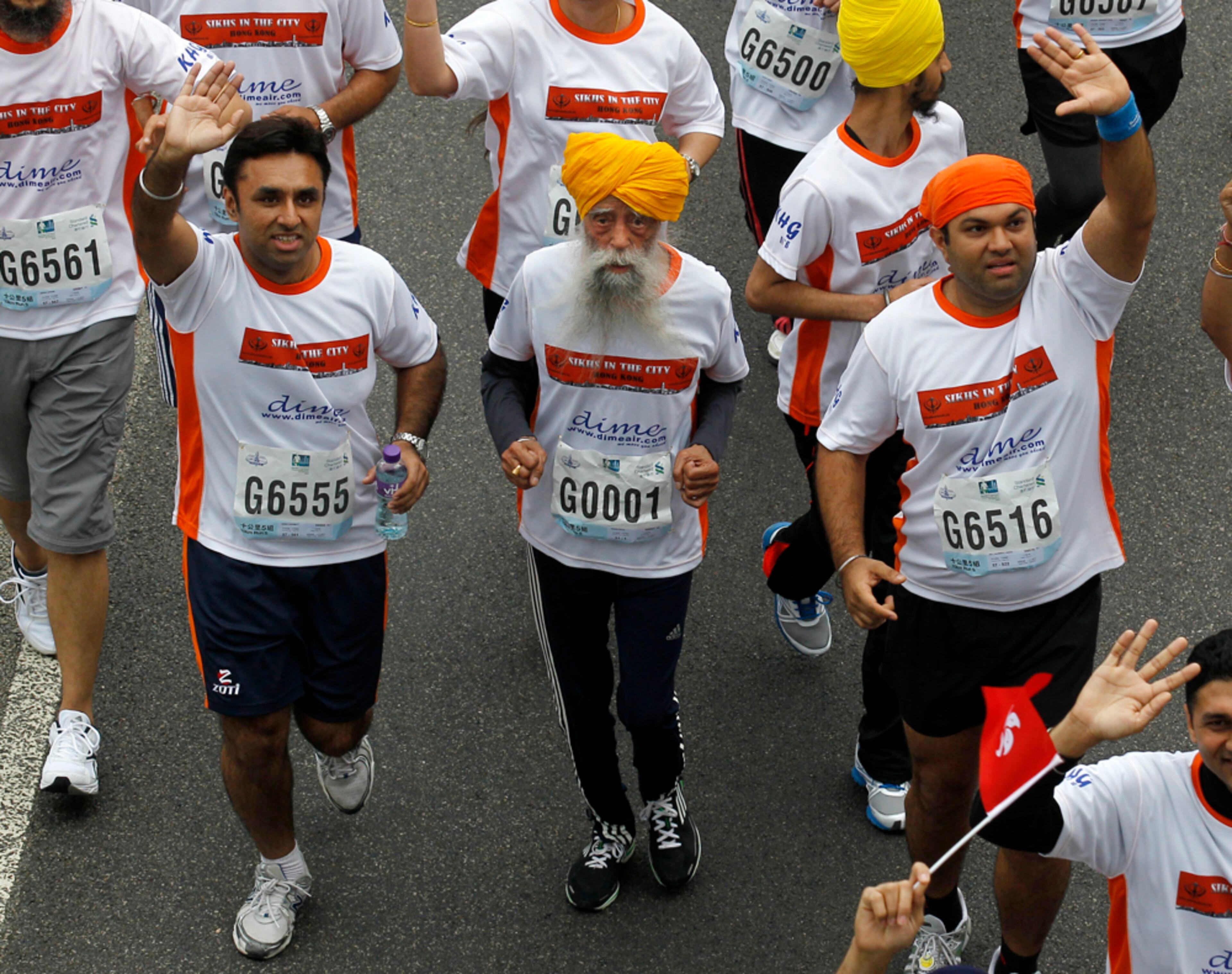 HIS RACE IS RUN--Centenarian marathon runner Fauja Singh, 101, center, originally from Beas Pind, in Jalandhar, India but who now lives in London, runs in a 10-kilometer race, part of the annual Hong Kong Marathon, in Hong Kong Sunday, Feb. 24, 2013. Singh will retire from public racing after competing in the marathon. (AP Photo/Kin Cheung)