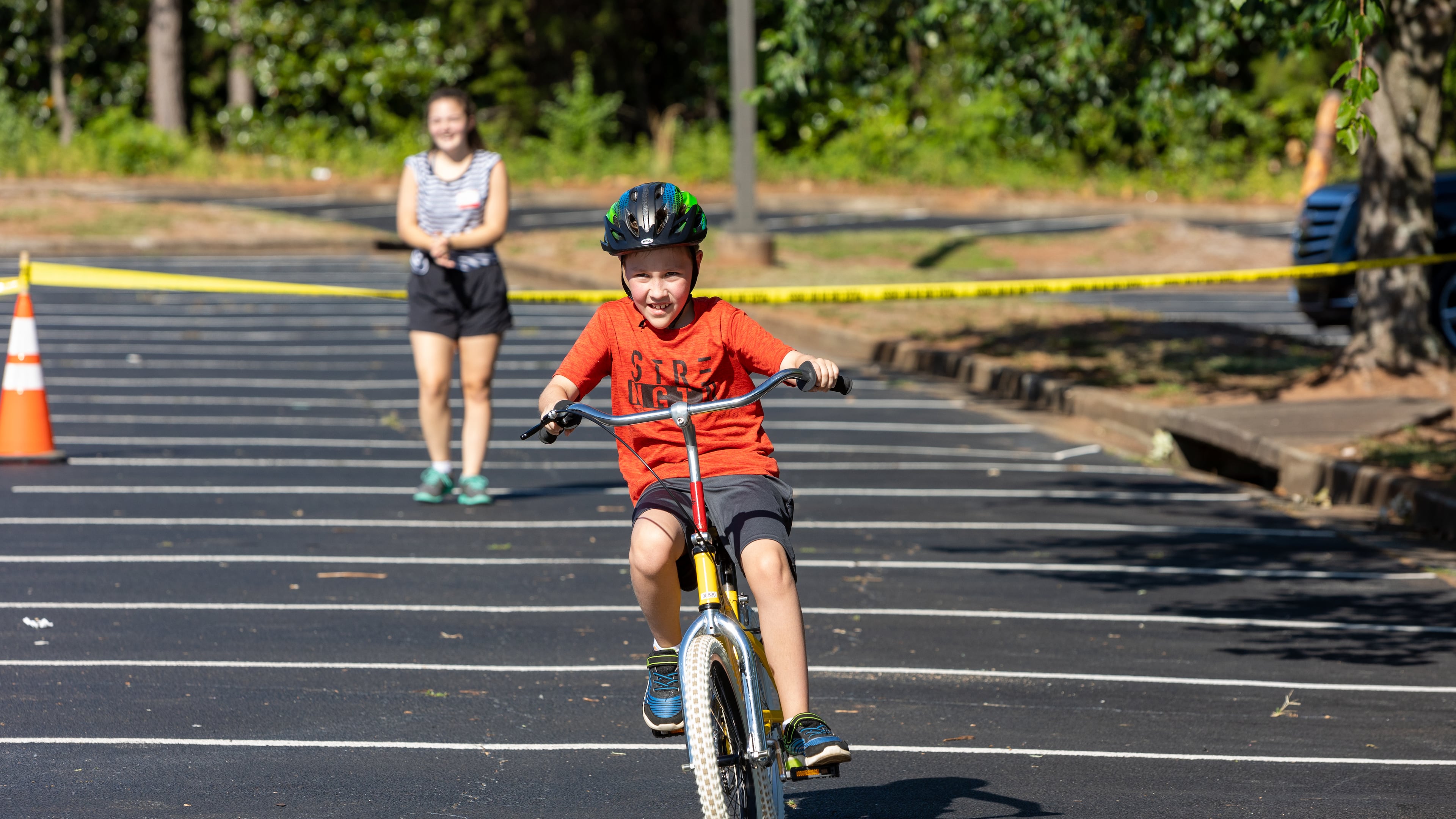 Special needs camper, Banks, takes a victory lap after learning how to ride a two-wheel bike without adaptations during the iCan Bike Alpharetta camp at The Cooler in Alpharetta. PHIL SKINNER FOR THE ATLANTA JOURNAL-CONSTITUTION.