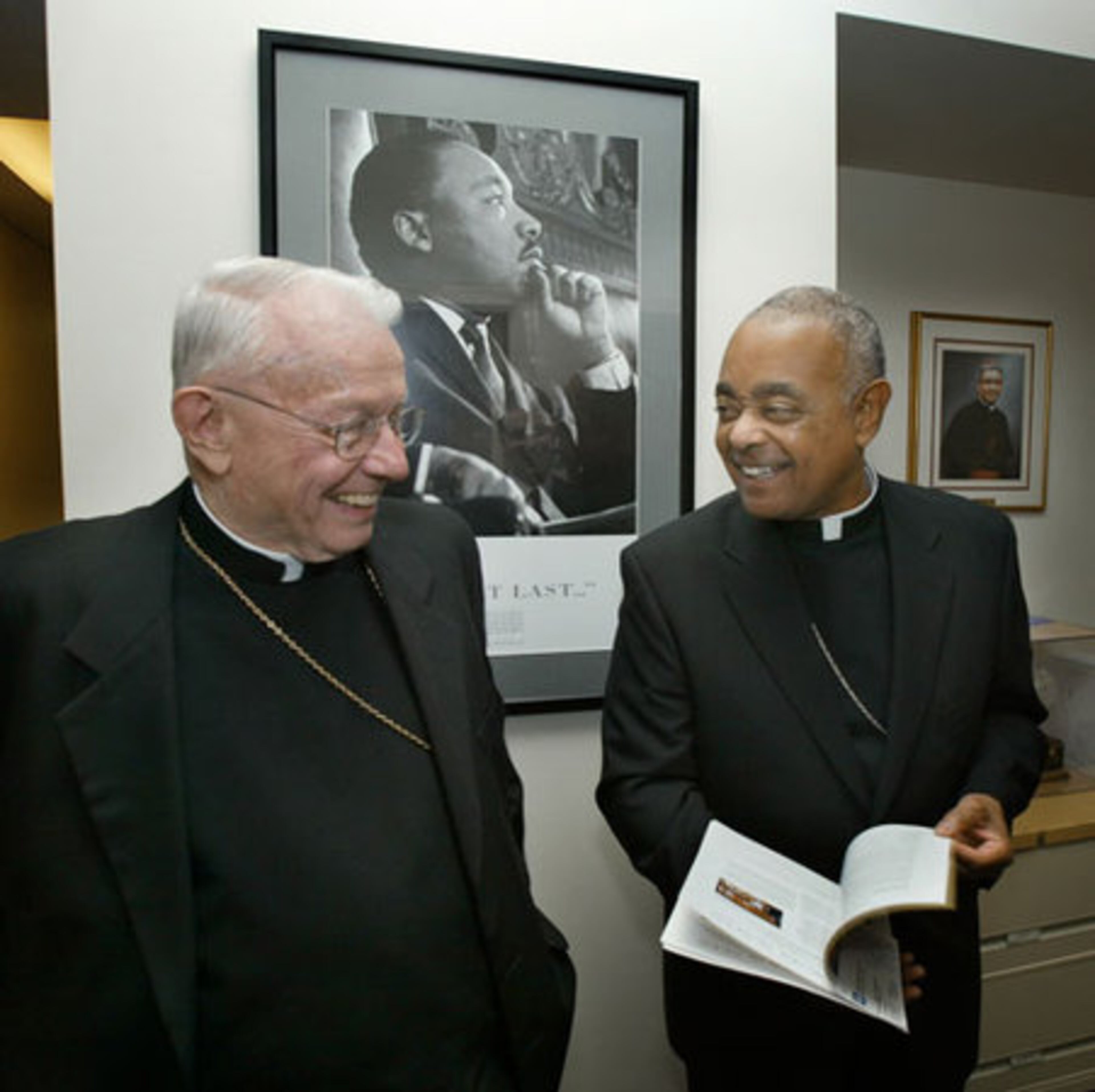 In this file photo from April 2009, Archbishop Donoghue jokes with then Archbishop-elect Gregory as he tours the offices of the Catholic Center in downtown Atlanta.