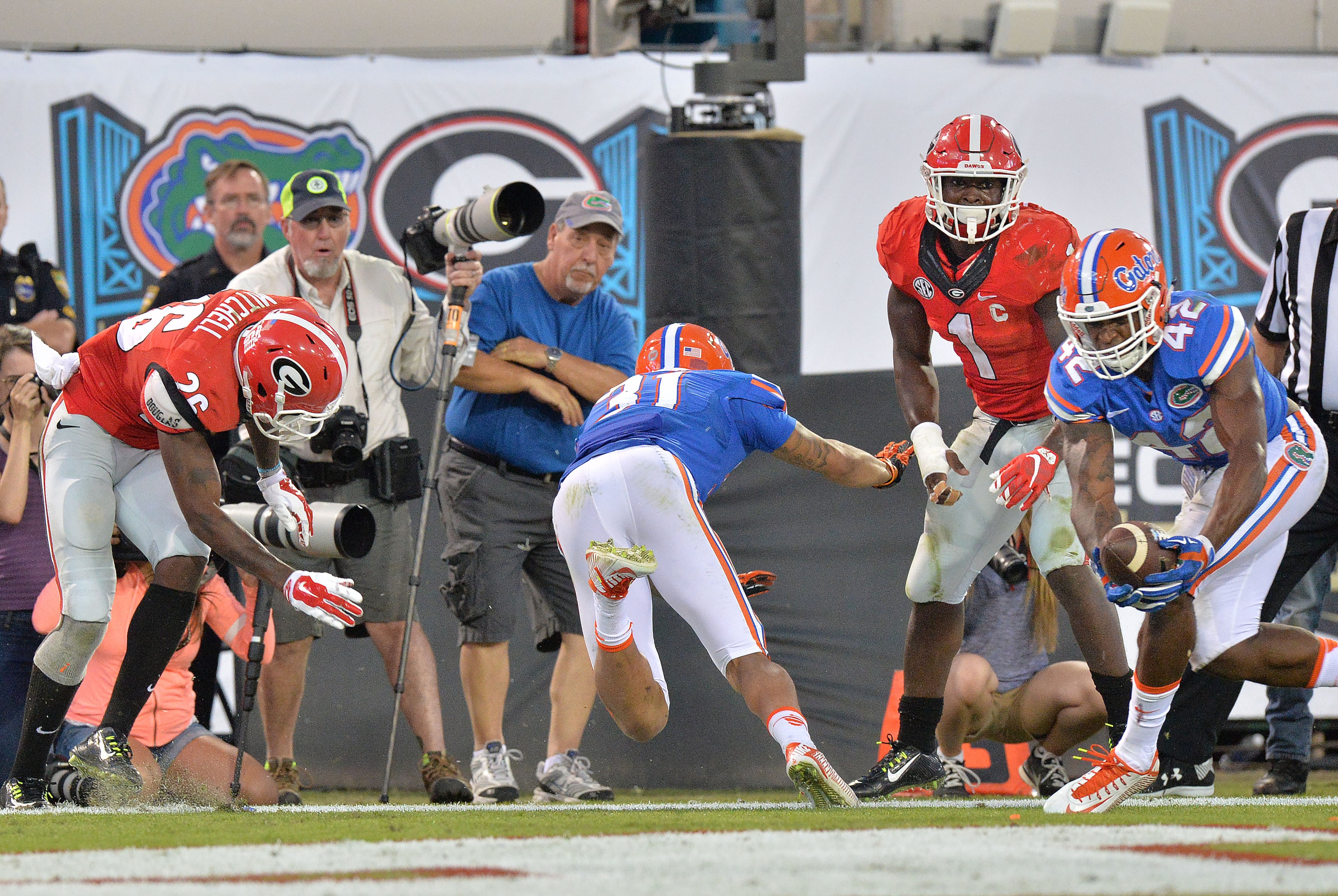 October 31, 2015 Jacksonville, Florida - Florida Gators defensive back Keanu Neal (42) catches the ball after Florida Gators defensive back Jalen Tabor (31) blocked a pass against Georgia Bulldogs wide receiver Malcolm Mitchell (26) in the second half at EverBank Field in Jacksonville, Florida on Saturday, October 31, 2015. Florida Gators won 27-3 over the Georgia Bulldogs. HYOSUB SHIN / HSHIN@AJC.COM
