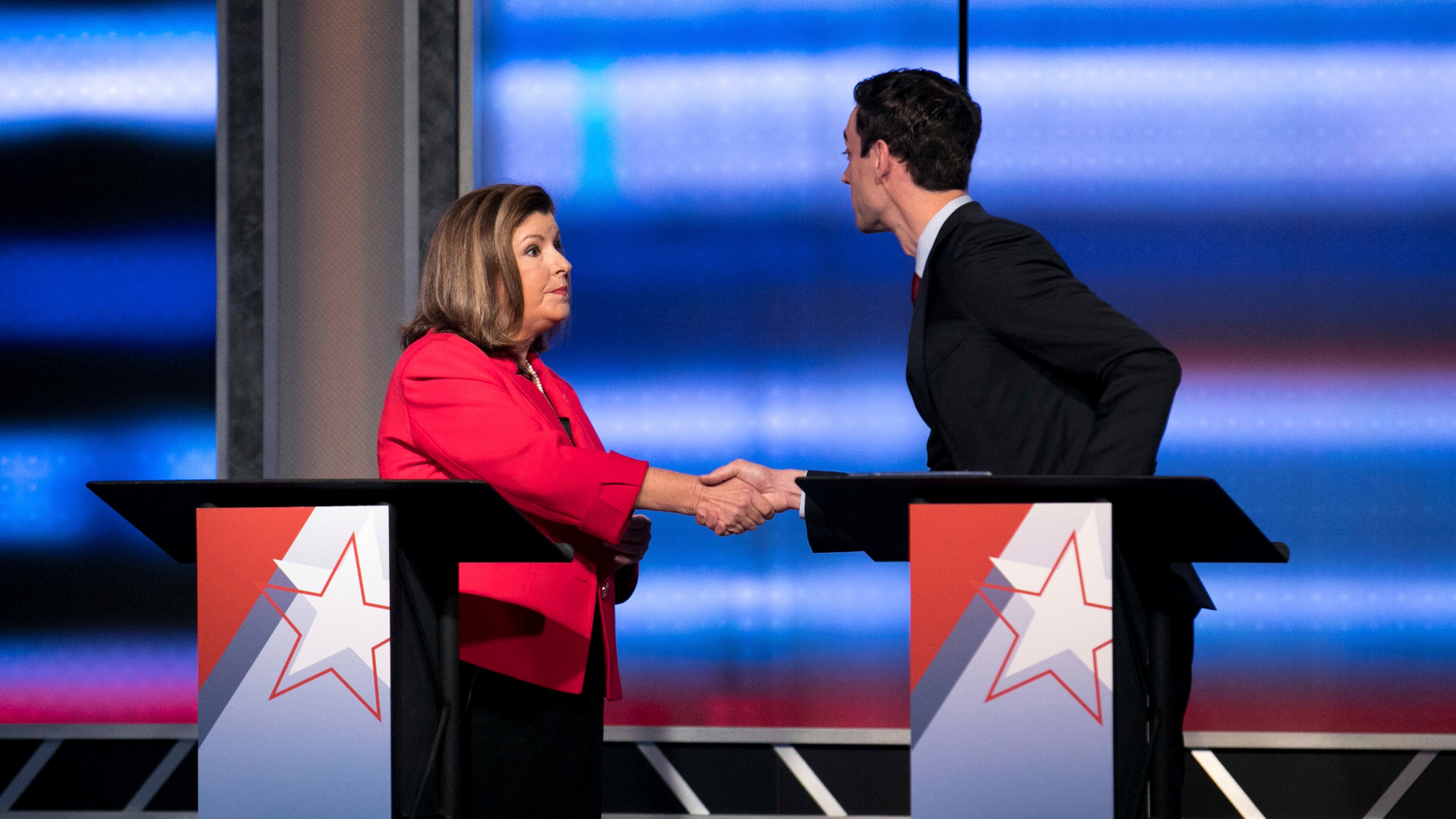 Candidates in Georgia's 6th Congressional District race Republican Karen Handel, left, and Democrat Jon Ossoff shake hands after a debate Tuesday, June 6, 2017, in Atlanta. The two meet in a June 20 special election. (Branden Camp/Atlanta Journal-Constitution via AP)