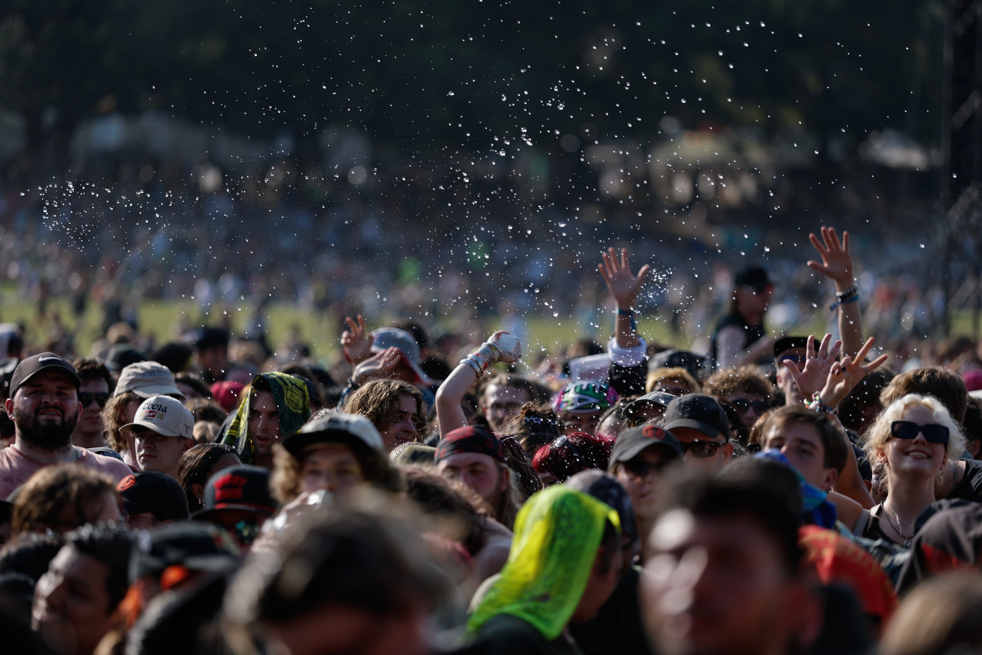 Fans try to keep cool as Peach Pit performs during the Shaky Knees music festival at Piedmont Park, Saturday, Sept. 19, 2026, in Atlanta. (Erik S. Lesser for the AJC)