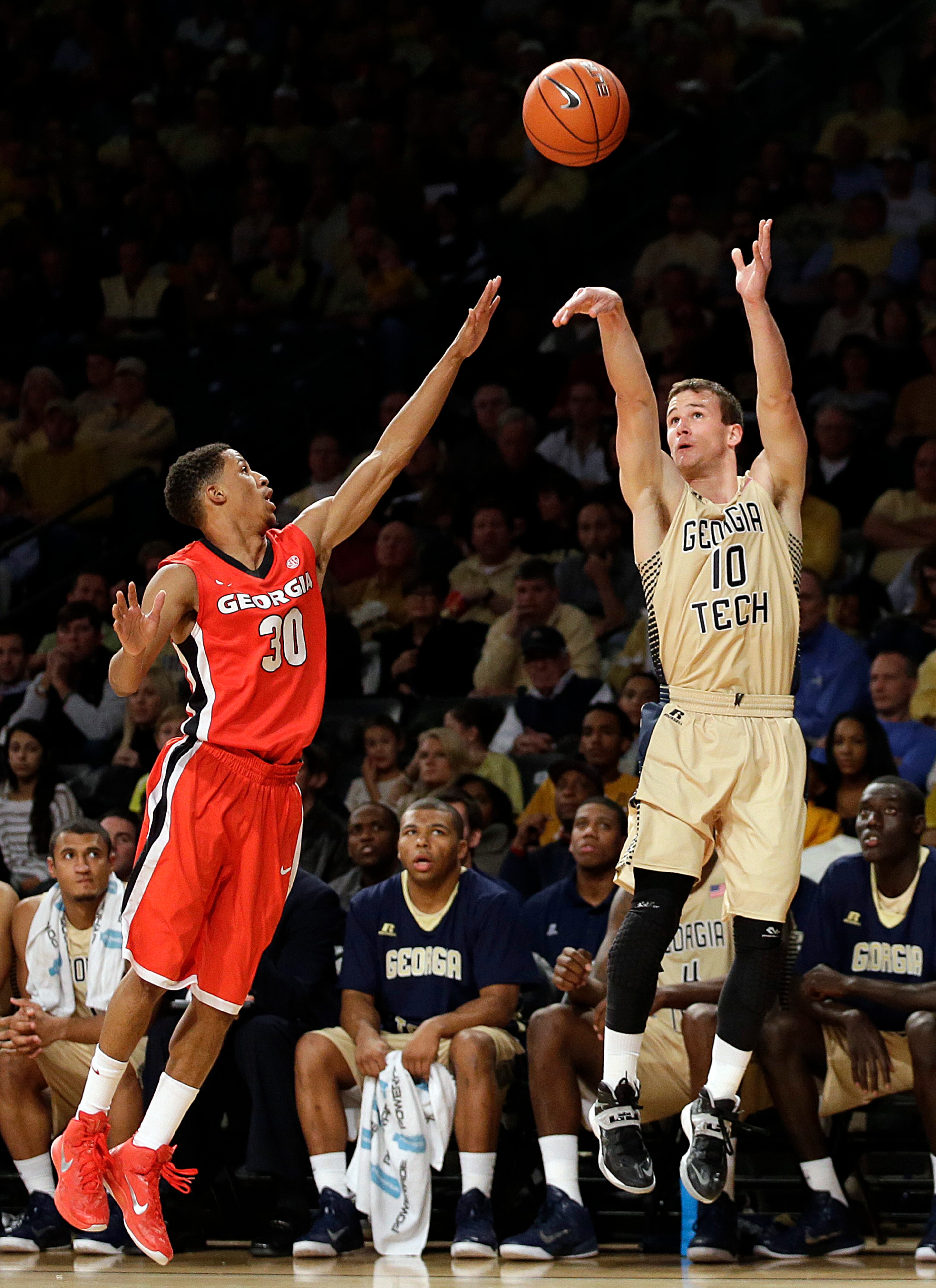 Georgia Tech's Travis Jorgenson, right, shoots over Georgia's J.J. Frazier in the second half of an NCAA college basketball game, Friday, Nov. 14, 2014, in Atlanta. Georgia Tech won 80-73. (AP Photo/David Goldman)