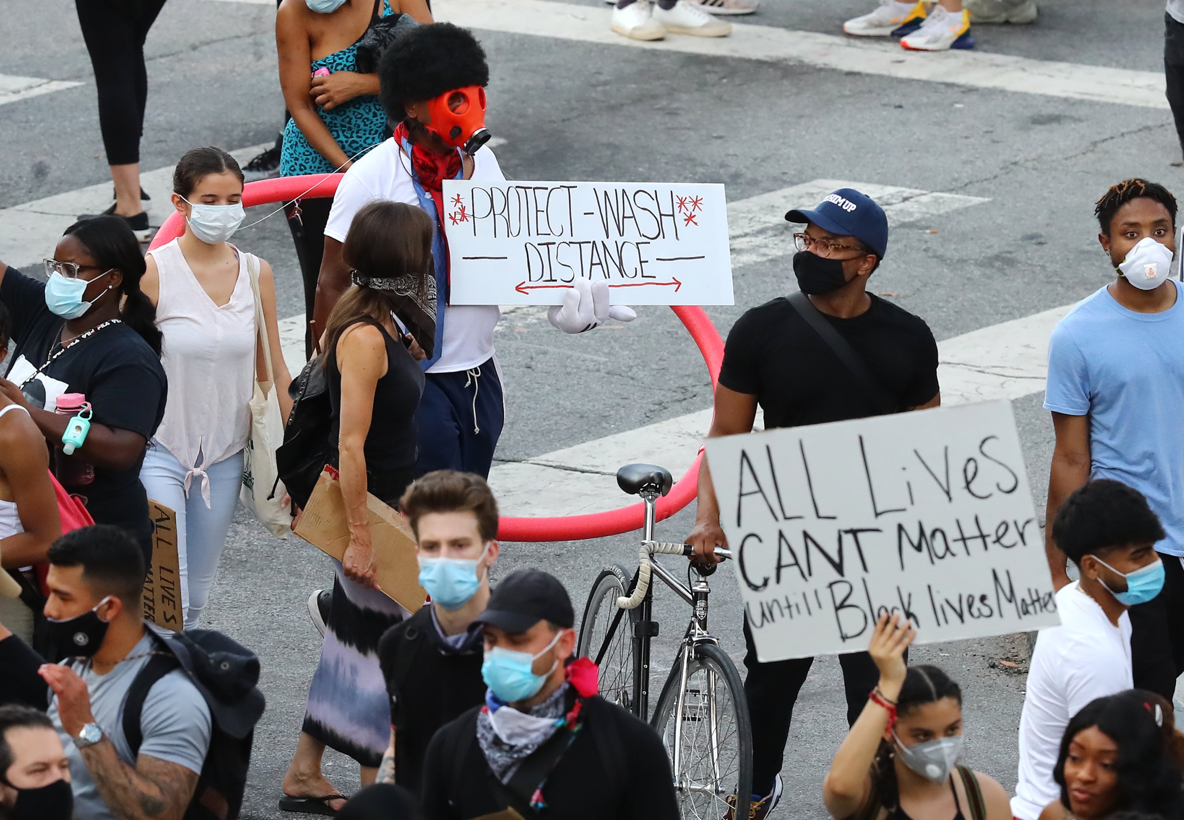 060220 Atlanta: One protester trys to remind others to protect, distance, and wash at Olympic Park during a fifth day of protests over the death of George Floyd on Tuesday, June 2, 2020, in Atlanta. Curtis Compton ccompton@ajc.com