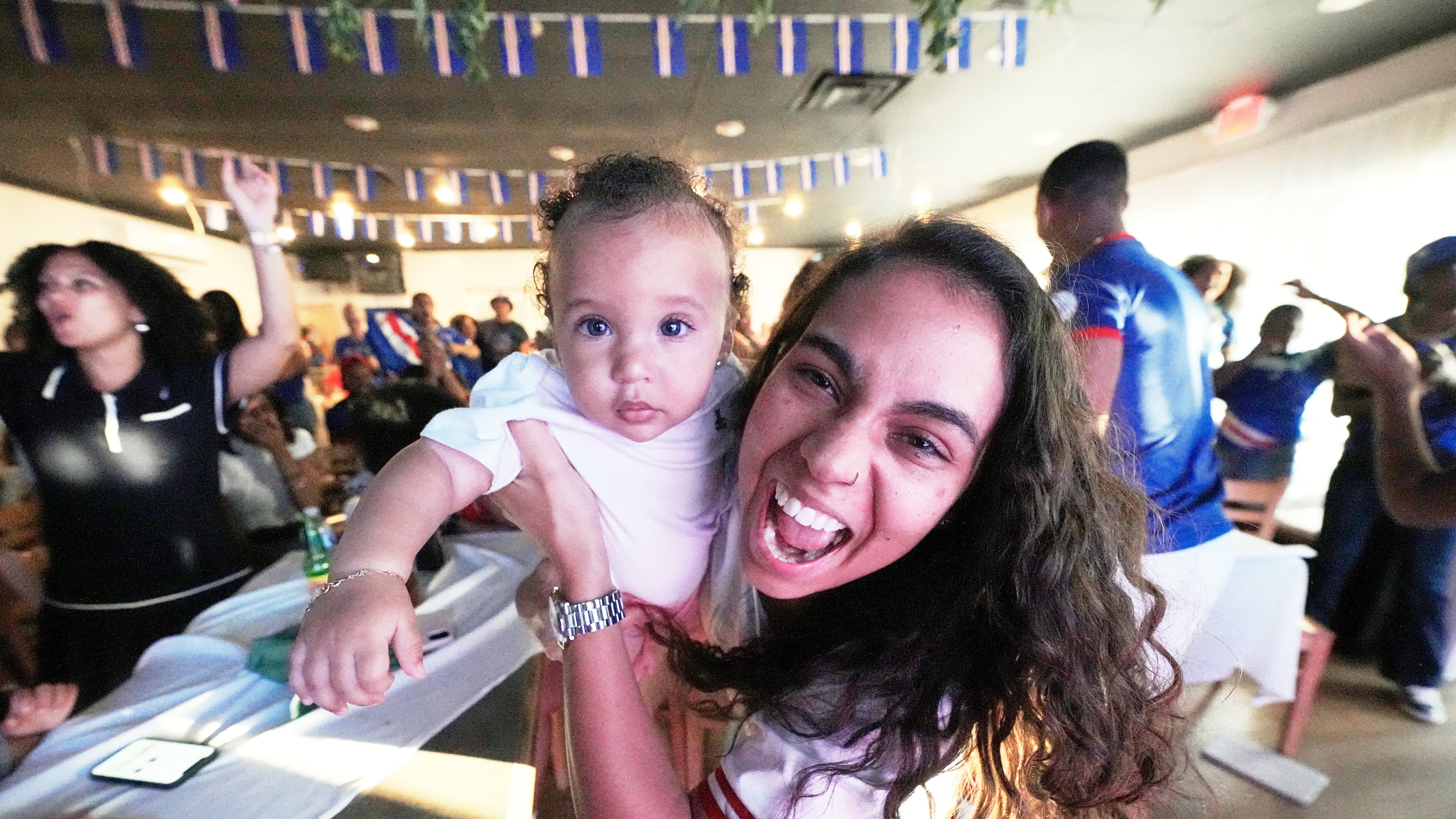 Cape Verde supporters celebrate their side's second goal as they watch the World Cup Group H soccer match between Uruguay and Cape Verde at a restaurant at a Cape Verde community in Brockton, Mass. near Boston, Sunday, June 21, 2026. (AP Photo/Martin Meissner)