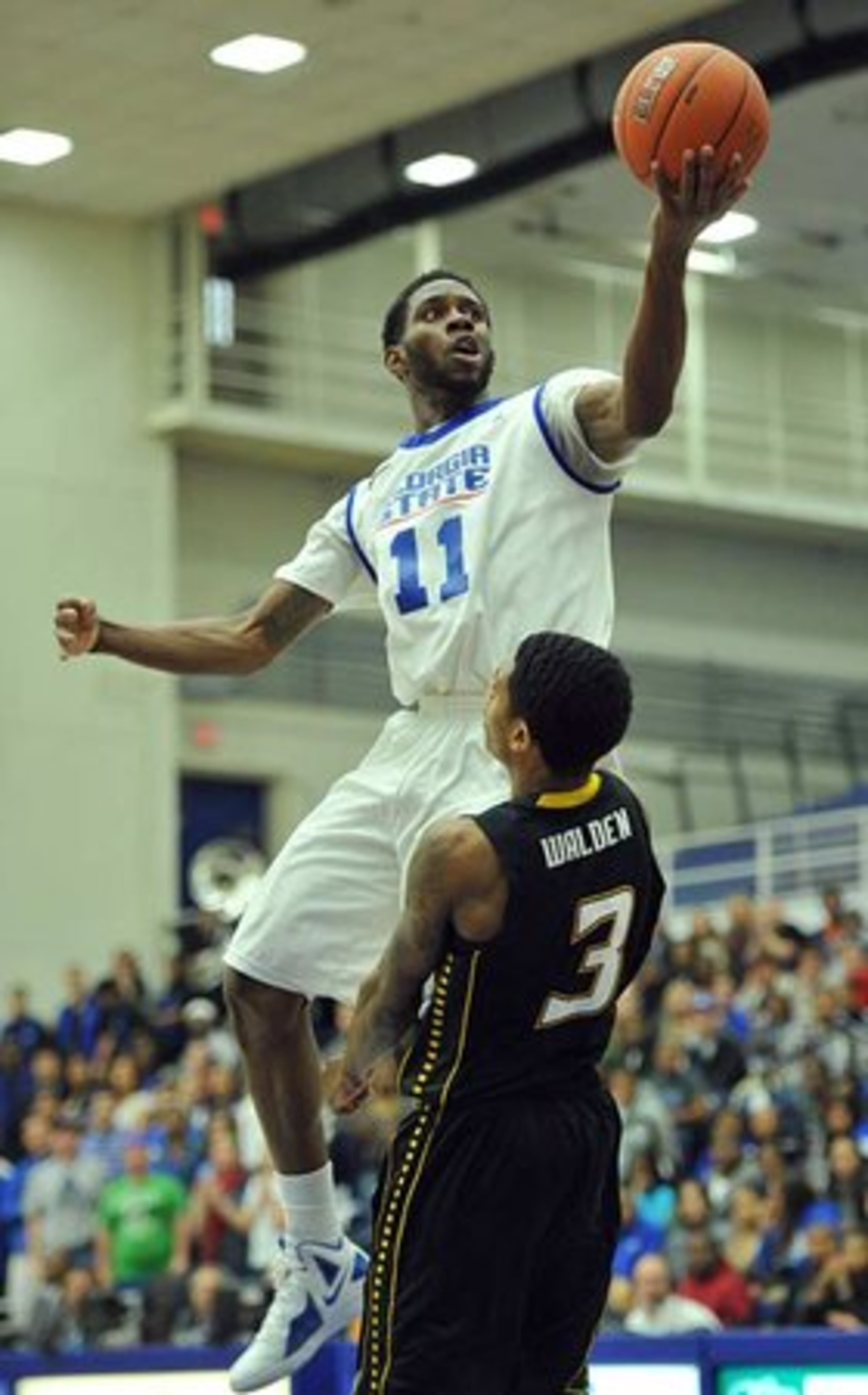 Tony Kimbro Jr. shoots over Towson guard Kris Walden in the second half.