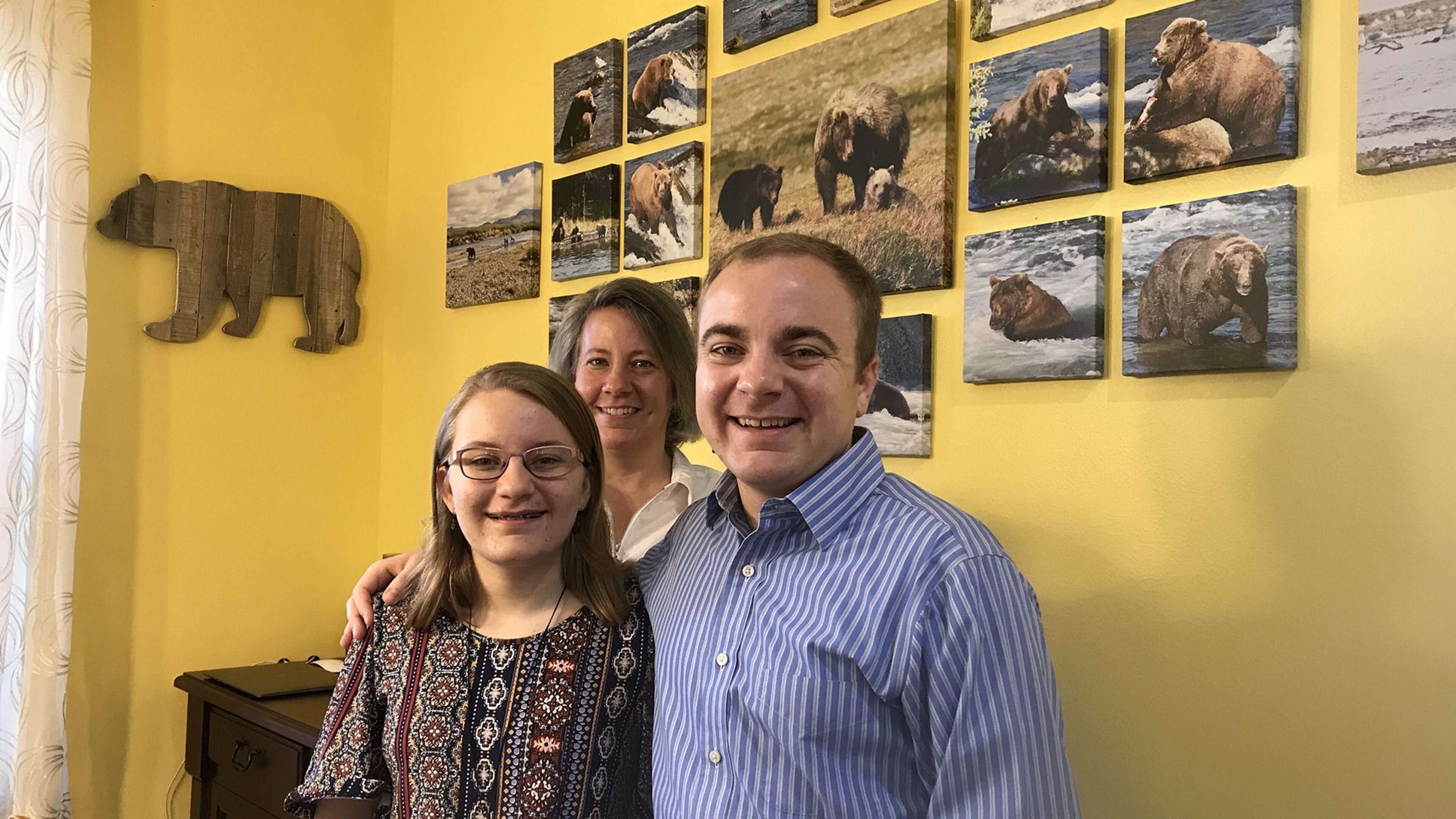 Megan Sorbo, left, with her mother, Tina, and brother, Trevor, at the family’s home near Orlando. The bear photographs on the wall were taken by Megan’s mom during a vacation to Katmai National Park and Preserve in Alaska. (Stephen Hudak/Orlando Sentinel/TNS)