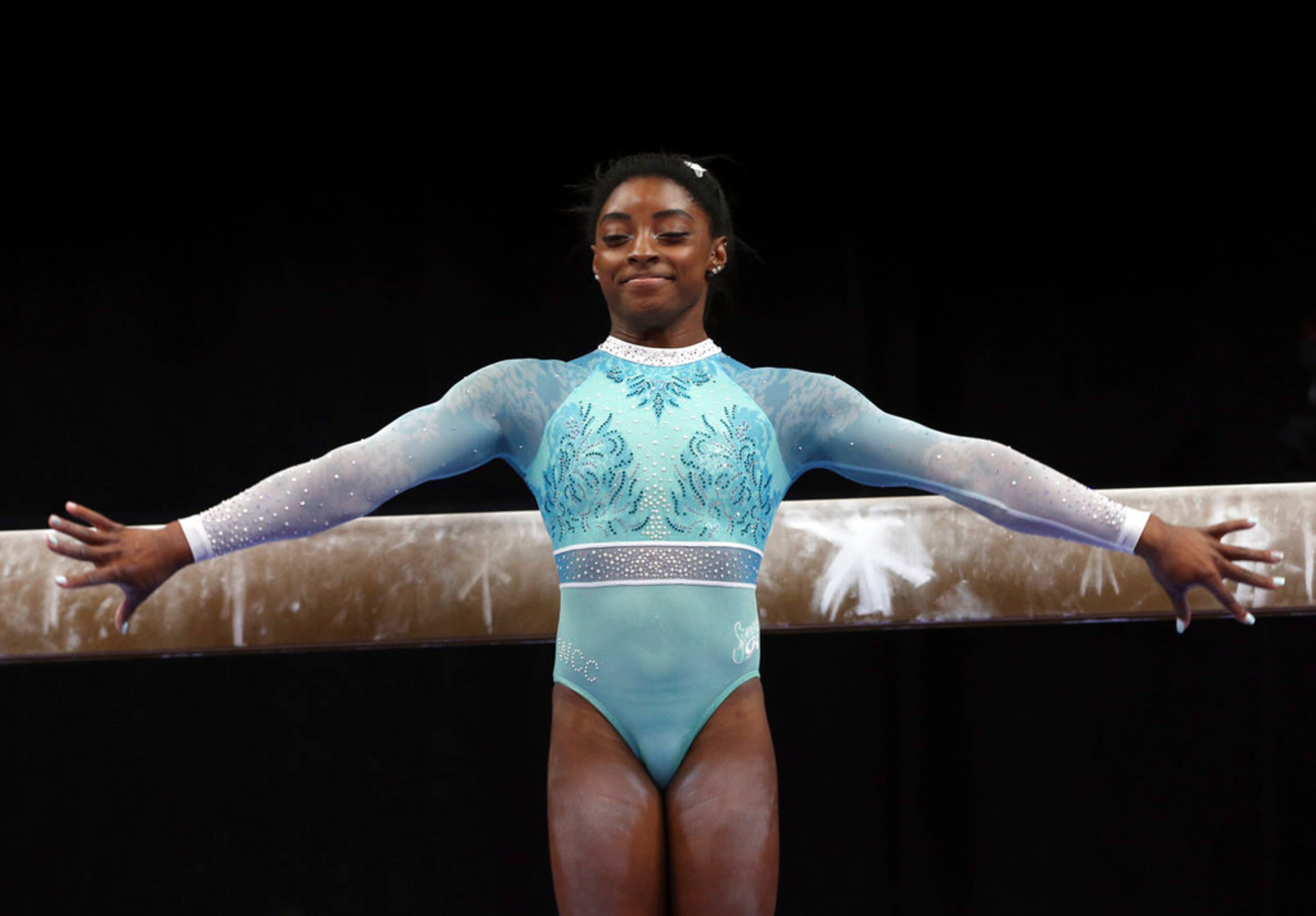 Simone Biles prepares to compete on the balance beam at the U.S. Gymnastics Championships, Sunday, Aug. 19, 2018, in Boston. (AP Photo/Elise Amendola)