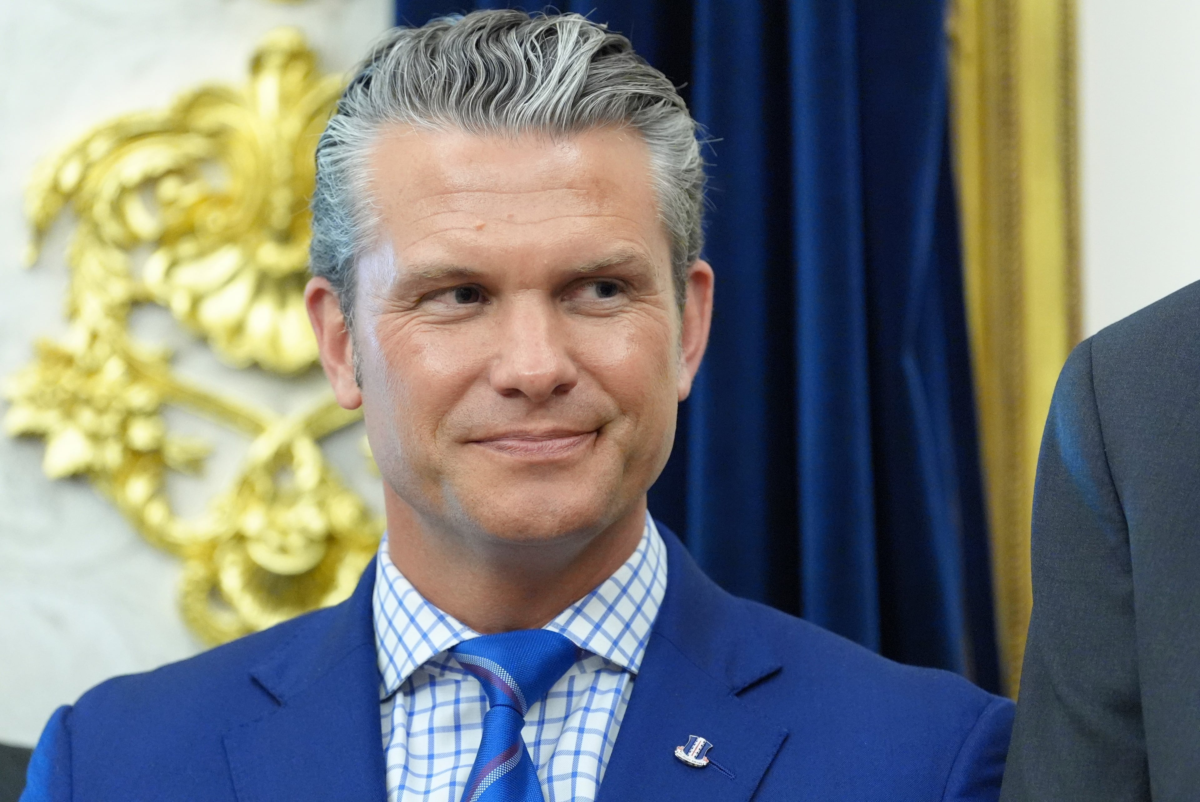 Defense Secretary Pete Hegseth listens as President Donald Trump speaks at the White House last month. (Jacquelyn Martin/AP)