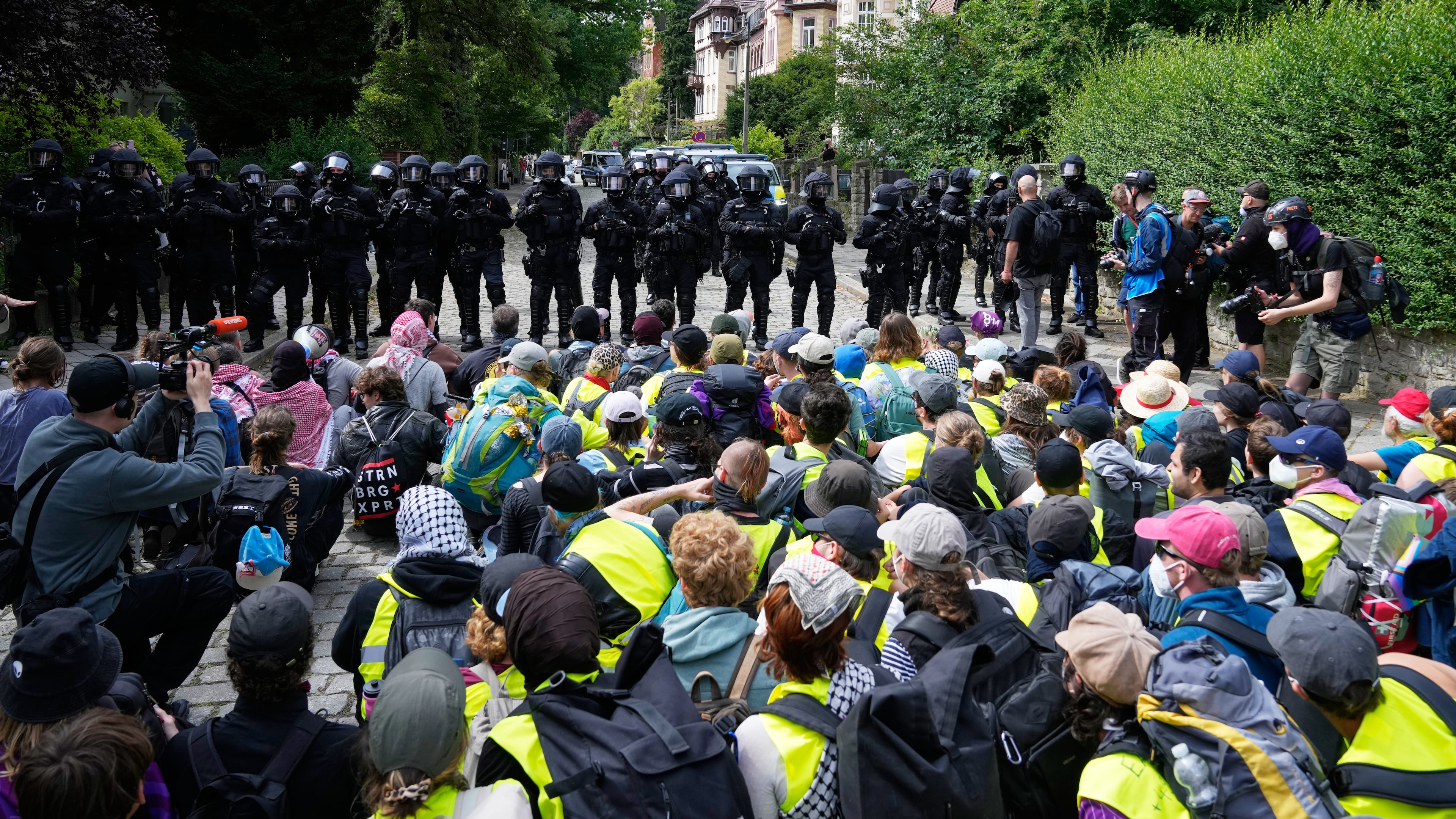 Police officers guard as protesters block a road during a rally against party convention of Alternative for Germany, or AfD in Erfurt, Germany, Saturday, July 4, 2026. (AP Photo/Ebrahim Noroozi)
