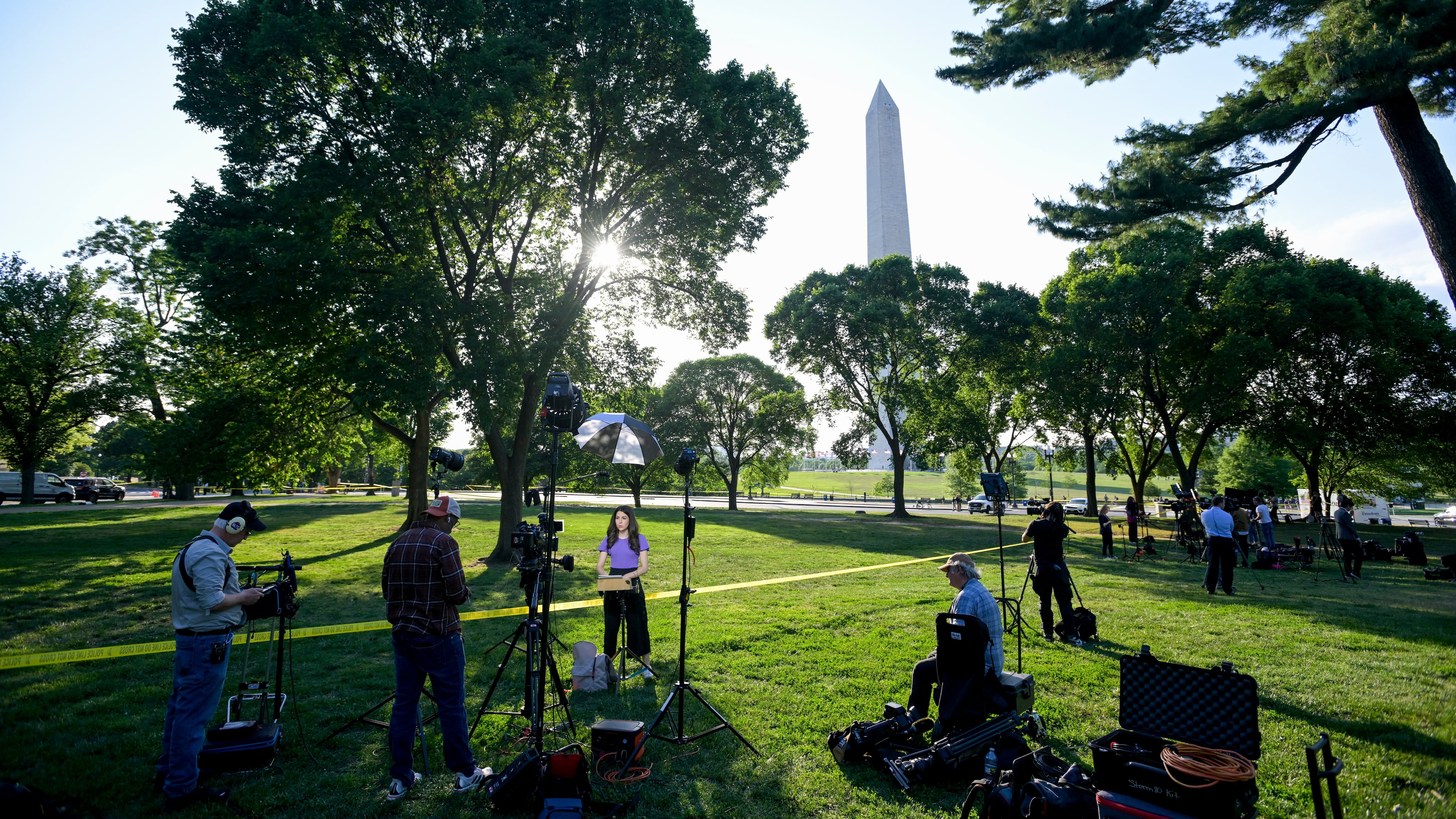 Journalists report as U.S. Secret Service and local police remain after a person was shot by law enforcement near the Washington Monument in Washington, Monday, May 4, 2026. (AP Photo/Rod Lamkey Jr.)