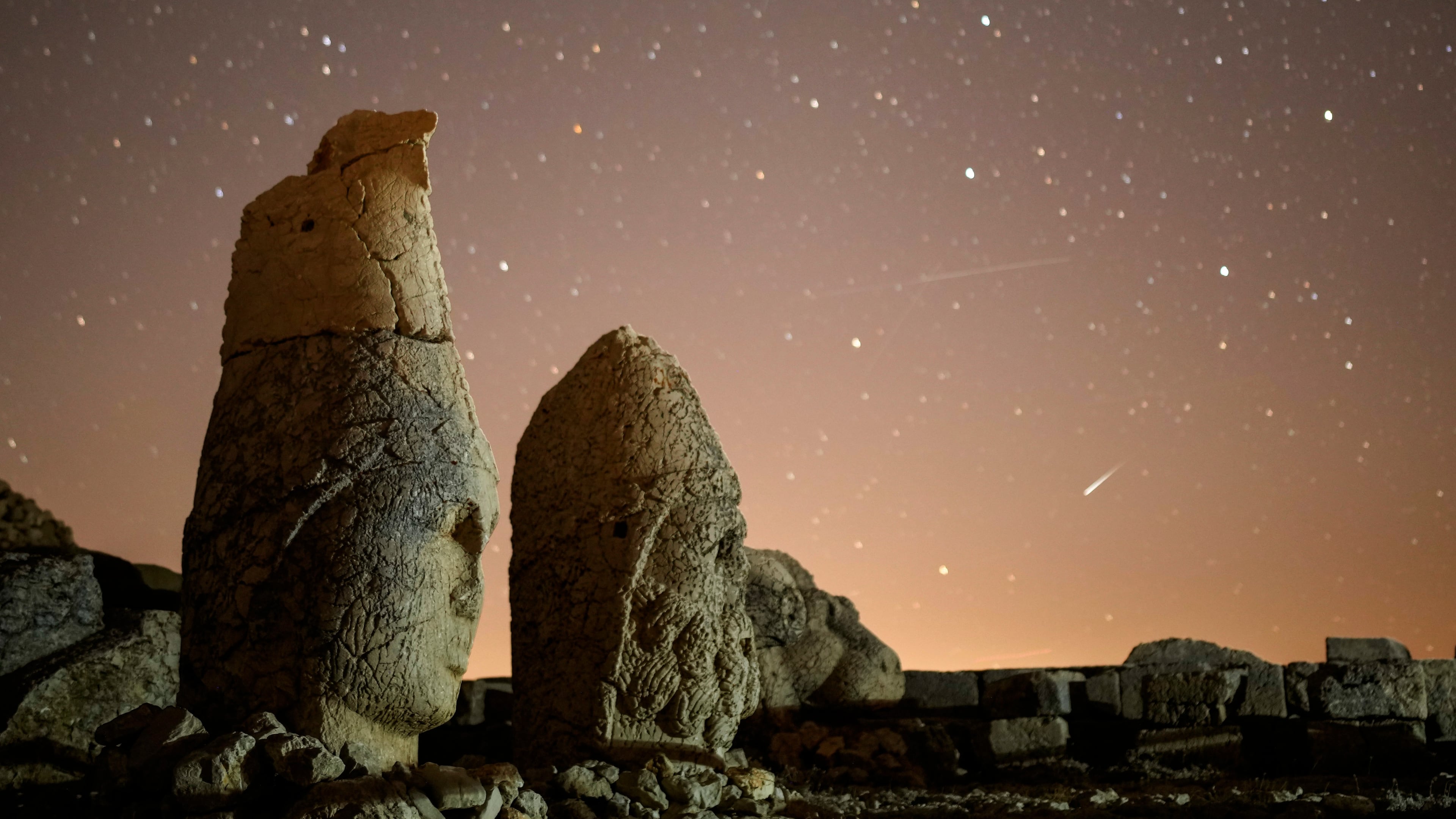 FILE - Ancient statues are seen during the Perseid meteor shower atop Mount Nemrut in southeastern Turkey, Sunday, Aug.11, 2024. (AP Photo/Emrah Gurel,File)