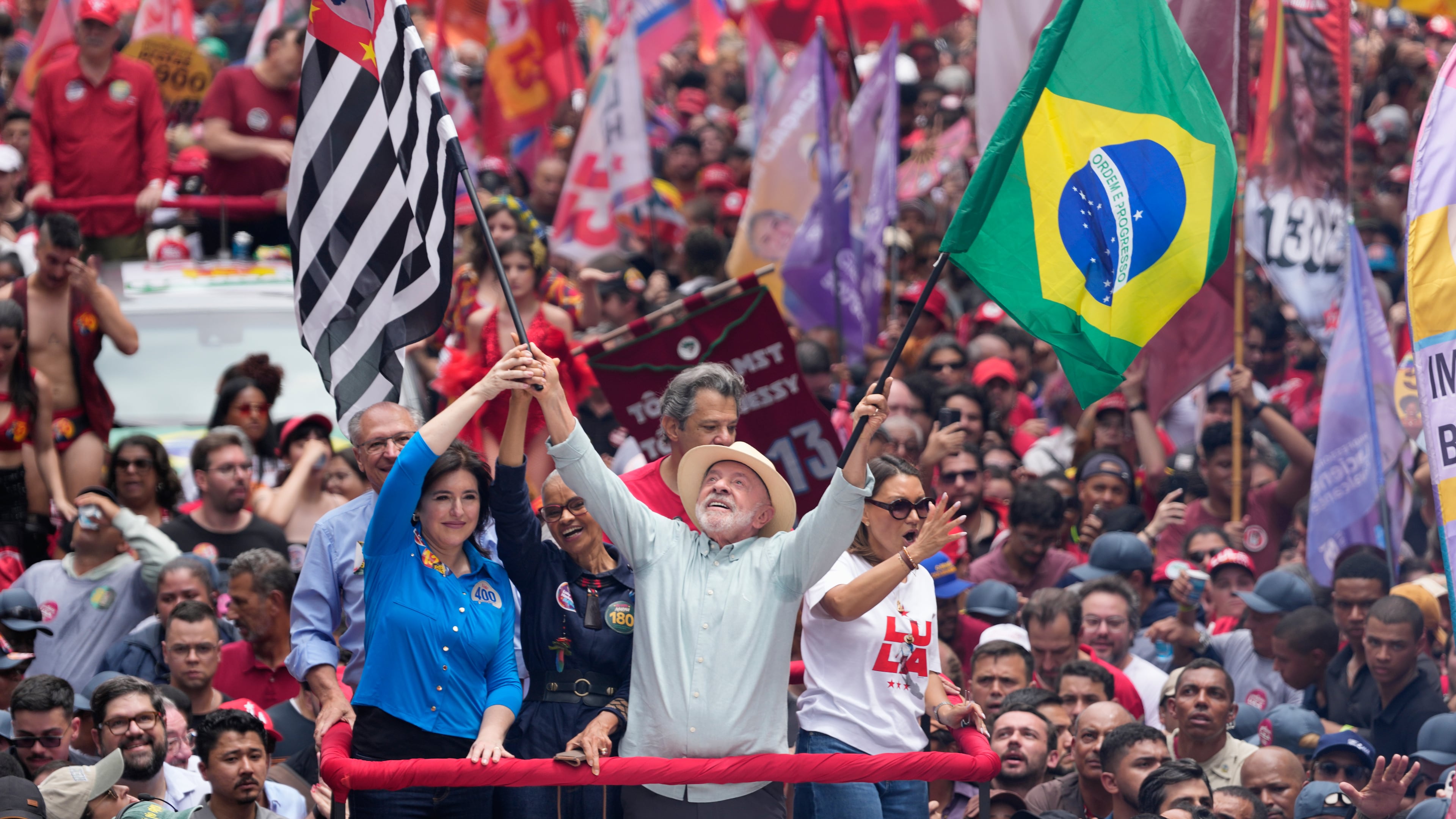 President Luiz Inacio Lula da Silva, who is running for reelection, waves a Brazilian and Sao Paulo state flags during a campaign rally a day ahead of the country's general election in Sao Paulo, Saturday, Oct. 3, 2026. (AP Photo/Andre Penner)