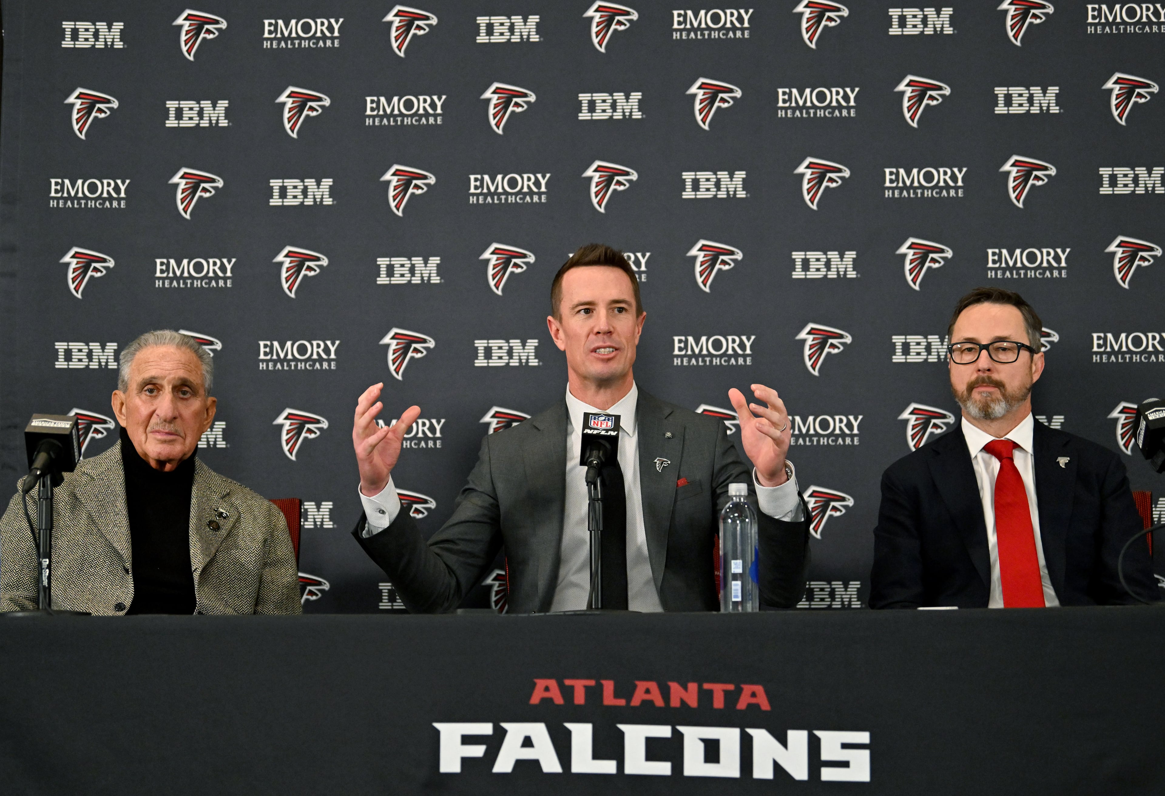 New Falcons president of football Matt Ryan speaks as Arthur M. Blank (left) and CEO Greg Beadles sit next him during a news conference to introduce new Falcons president of football Matt Ryan, Tuesday, Jan. 13, 2026, in Flowery Branch. (Hyosub Shin/AJC)
