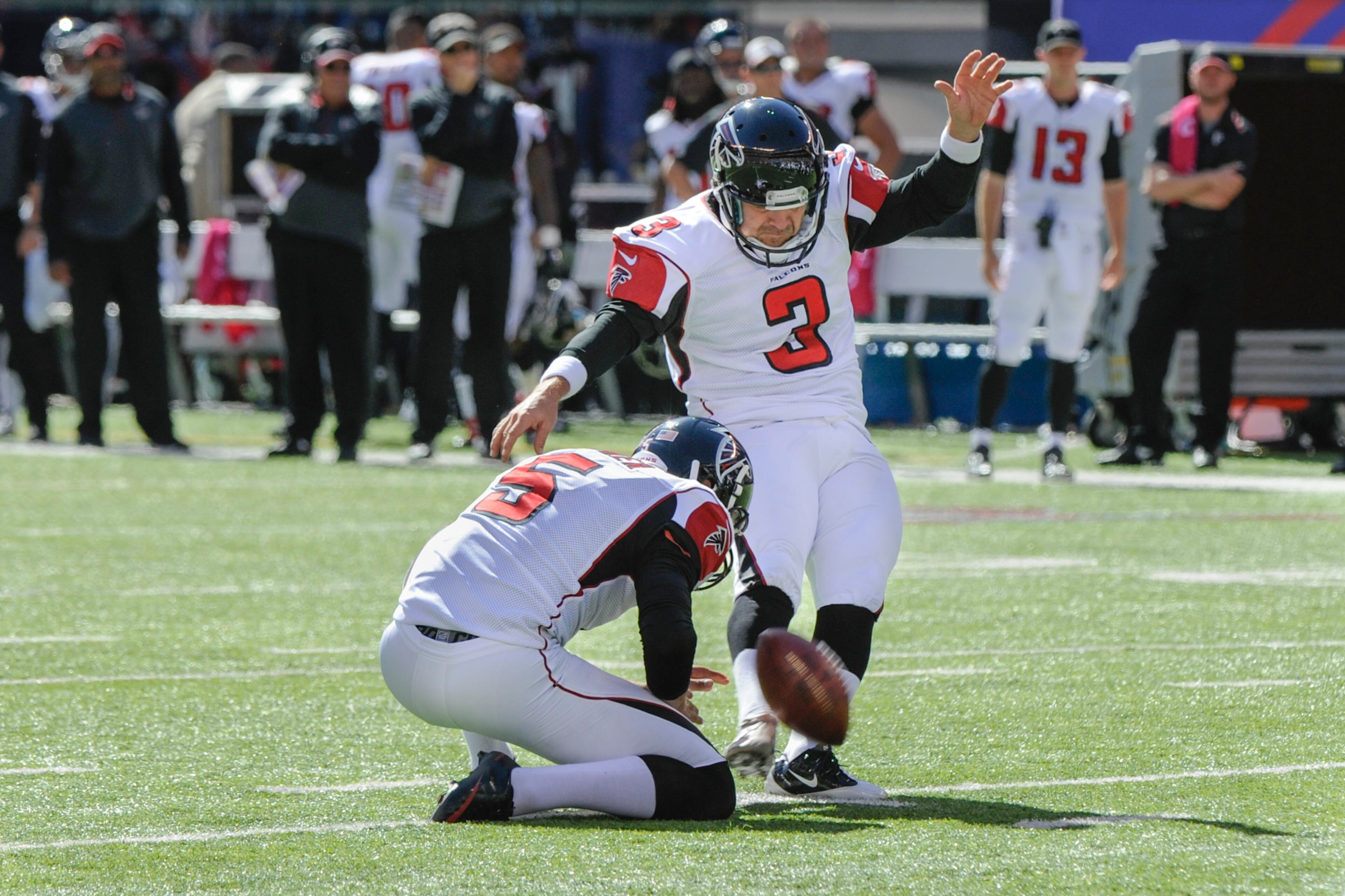 Atlanta Falcons kicker Matt Bryant, right, Matt Bosher holding, kicks a field goal against the New York Giants during the first half of an NFL football game, Sunday, Oct. 5, 2014, in East Rutherford, N.J. (AP Photo/Bill Kostroun)