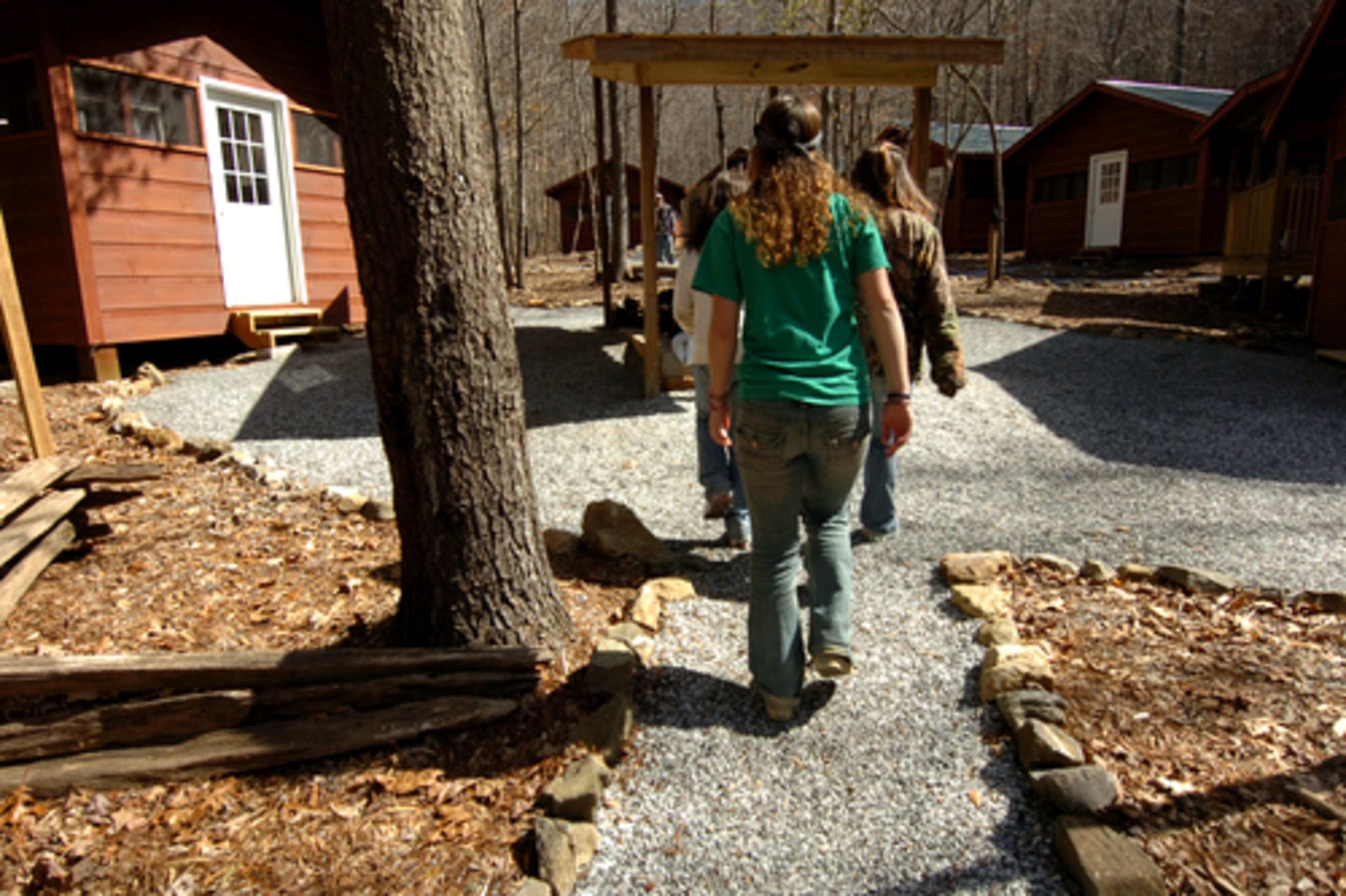 Girls walk to their cabins. "Kids typically are angry when they get here, angry at their parents for sending them away, angry at us for being here, just angry," says director Tim McMahon says. "We address that on Day One, asking them why they are here and helping them with their initial treatment plan, then their master plan."