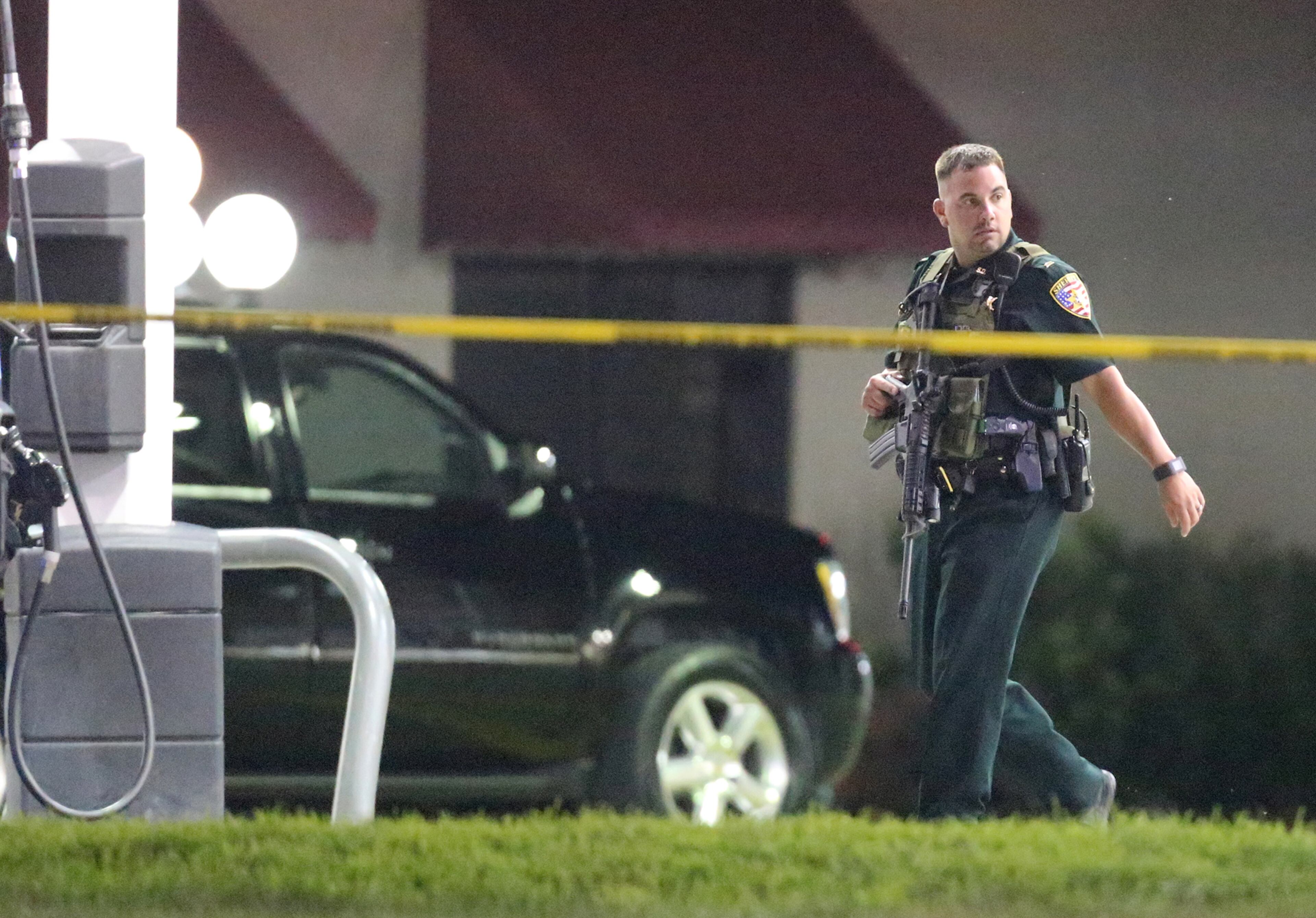 A law enforcement official works the scene where three Baton Rouge police officers were killed by the B-Quik gas station on Sunday, July 17, 2016, in Baton Rouge. In a city already tense after a high-profile police shooting of an African-American man, three Baton Rouge police officers were killed and three others wounded. Curtis Compton /ccompton@ajc.com