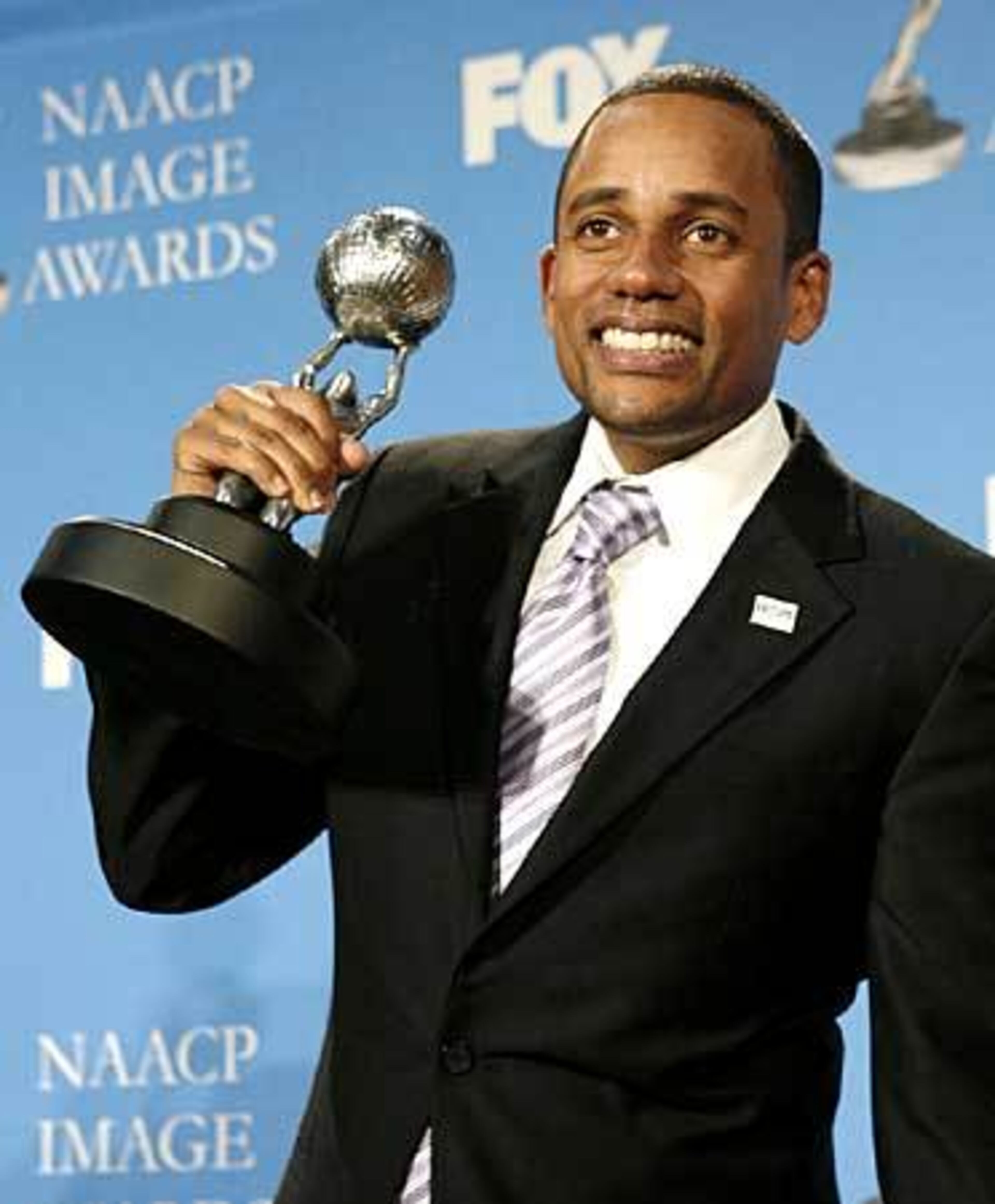 Hill Harper poses with the award for best outstanding actor in a drama series for "CSI: NY."