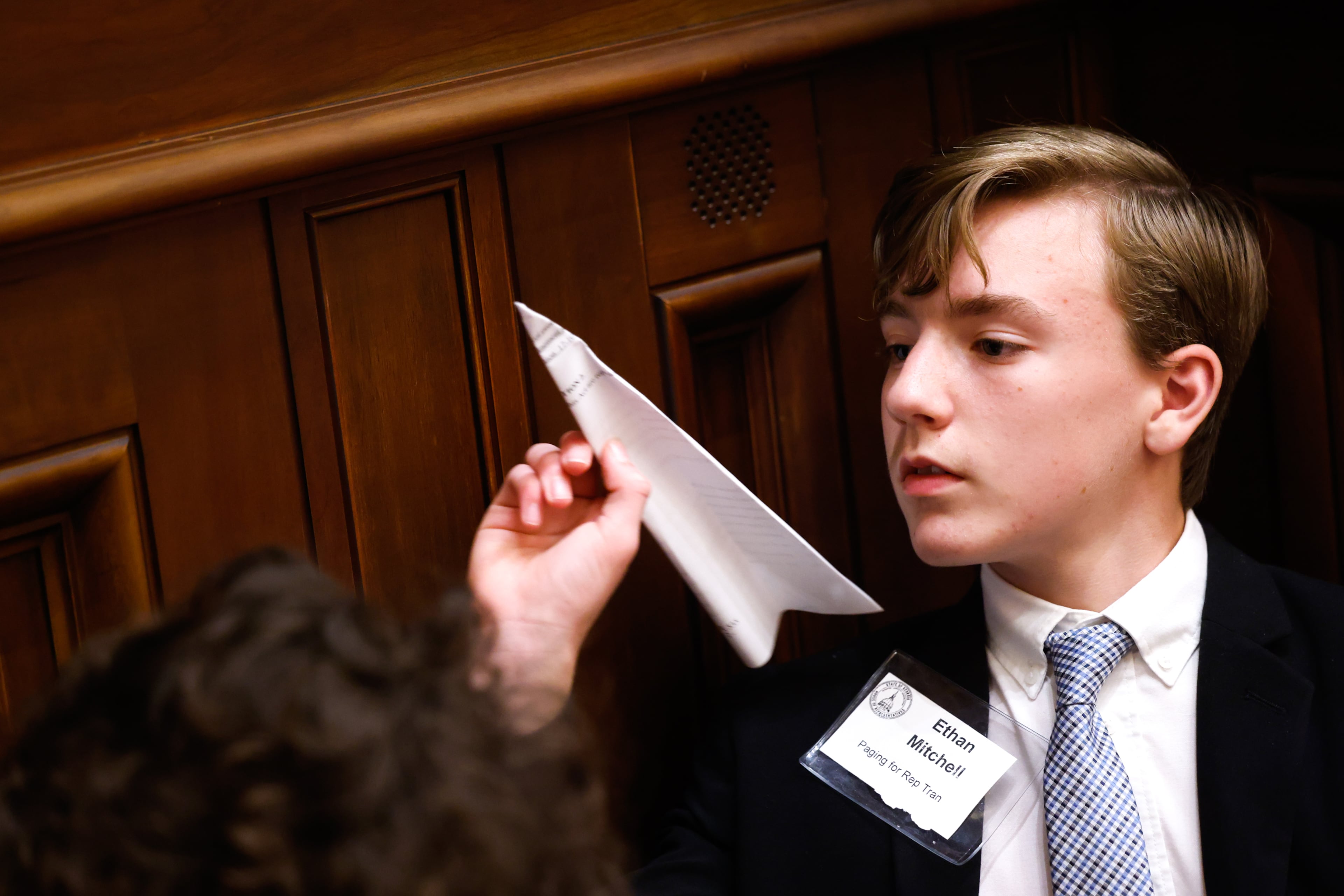 Page Ethan Mitchell tosses a paper airplane at the House of Representatives on Sine Die, the last day of the legislative session, at the Capitol in Atlanta on April 3, 2026. (Arvin Temkar/AJC)