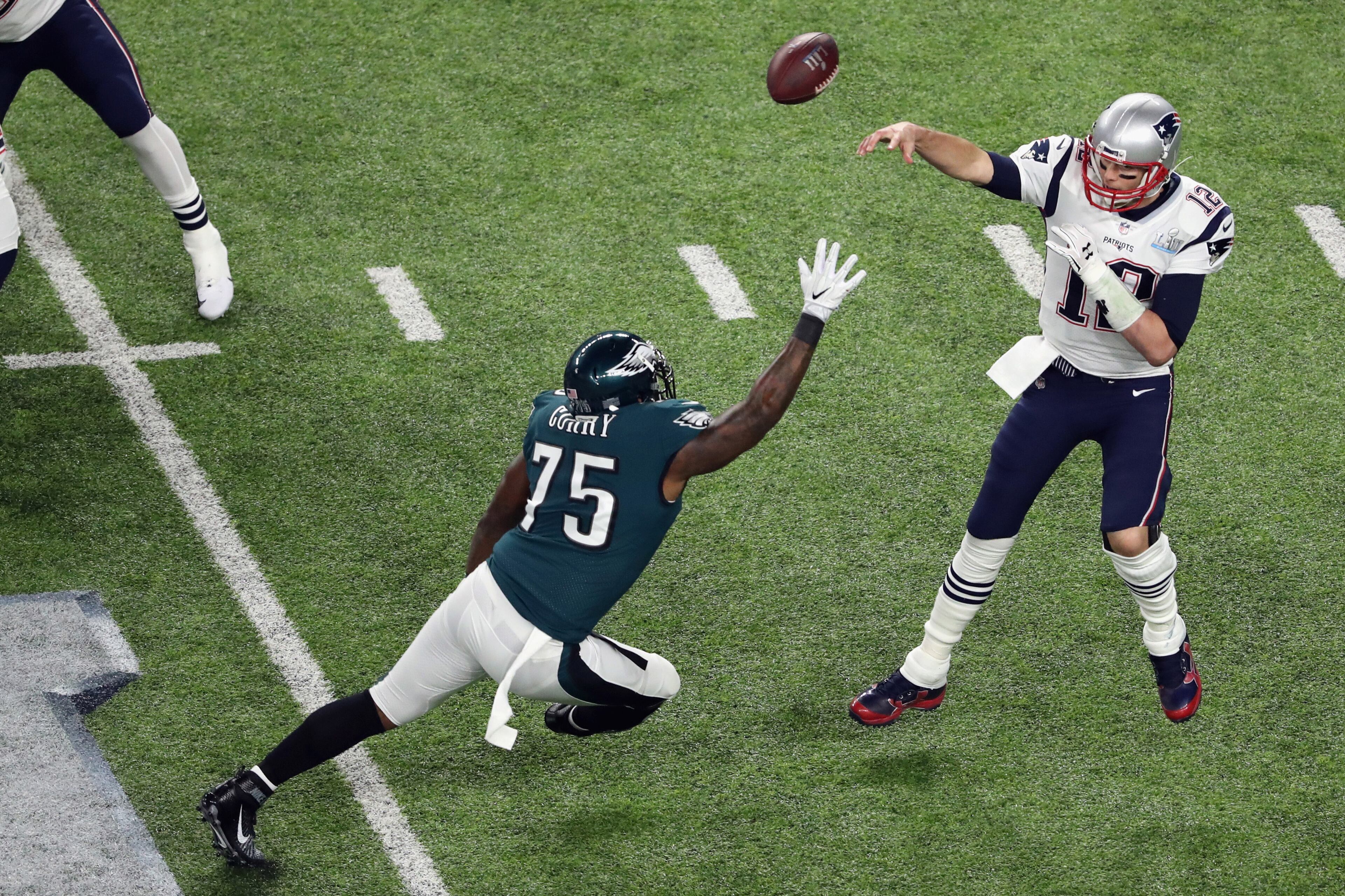 MINNEAPOLIS, MN - FEBRUARY 04: Tom Brady #12 of the New England Patriots attempts a pass against Vinny Curry #75 of the Philadelphia Eagles in the first quarter of Super Bowl LII at U.S. Bank Stadium on February 4, 2018 in Minneapolis, Minnesota. (Photo by Christian Petersen/Getty Images)