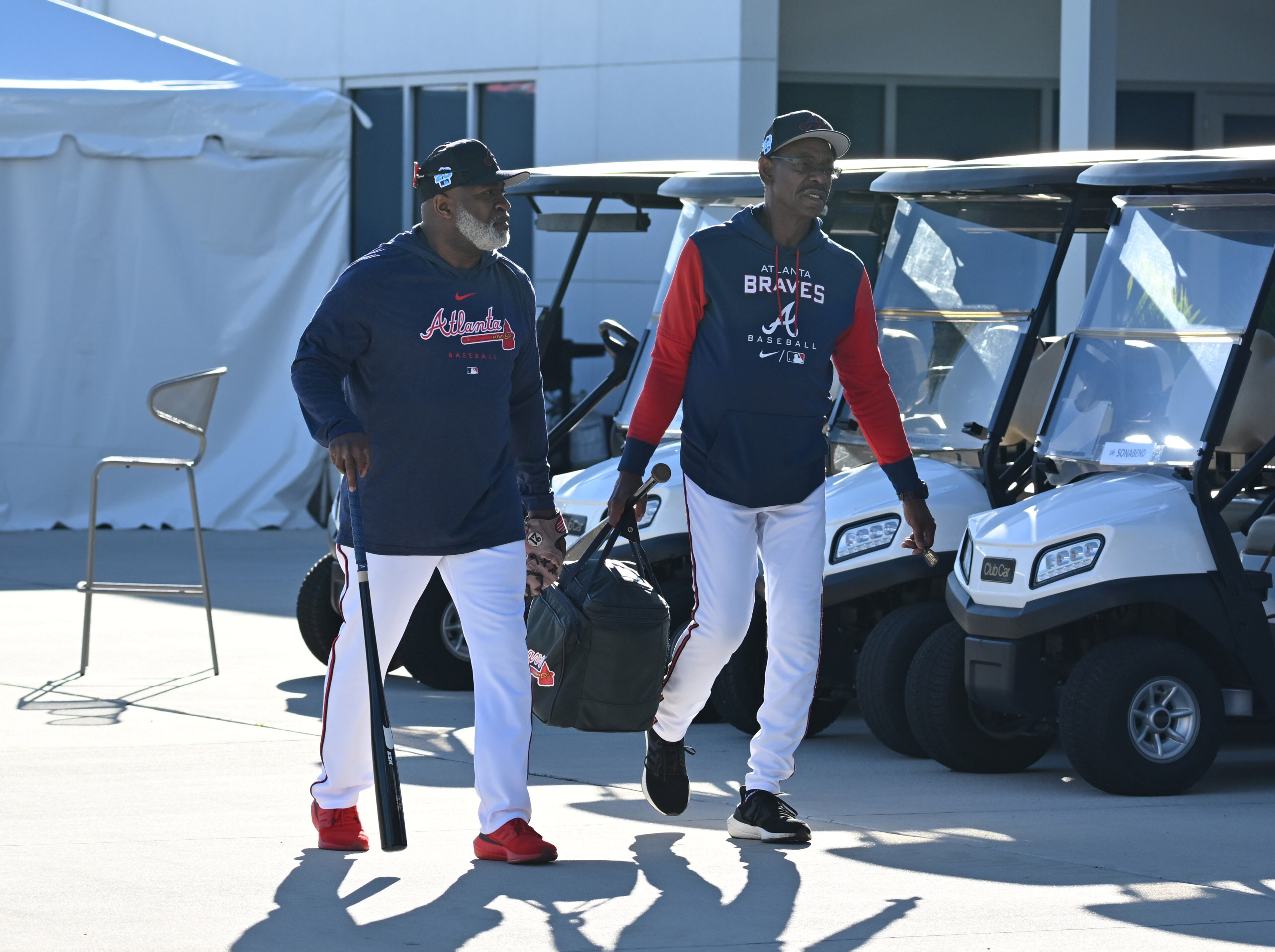 Braves first base coach Eric Young Sr. (left) and third base coach Ron Washington arrive on the first day pitchers and catchers reported to spring training at CoolToday Park, Monday, Feb. 13, 2023, in North Port, Fla. (Hyosub Shin / Hyosub.Shin@ajc.com)