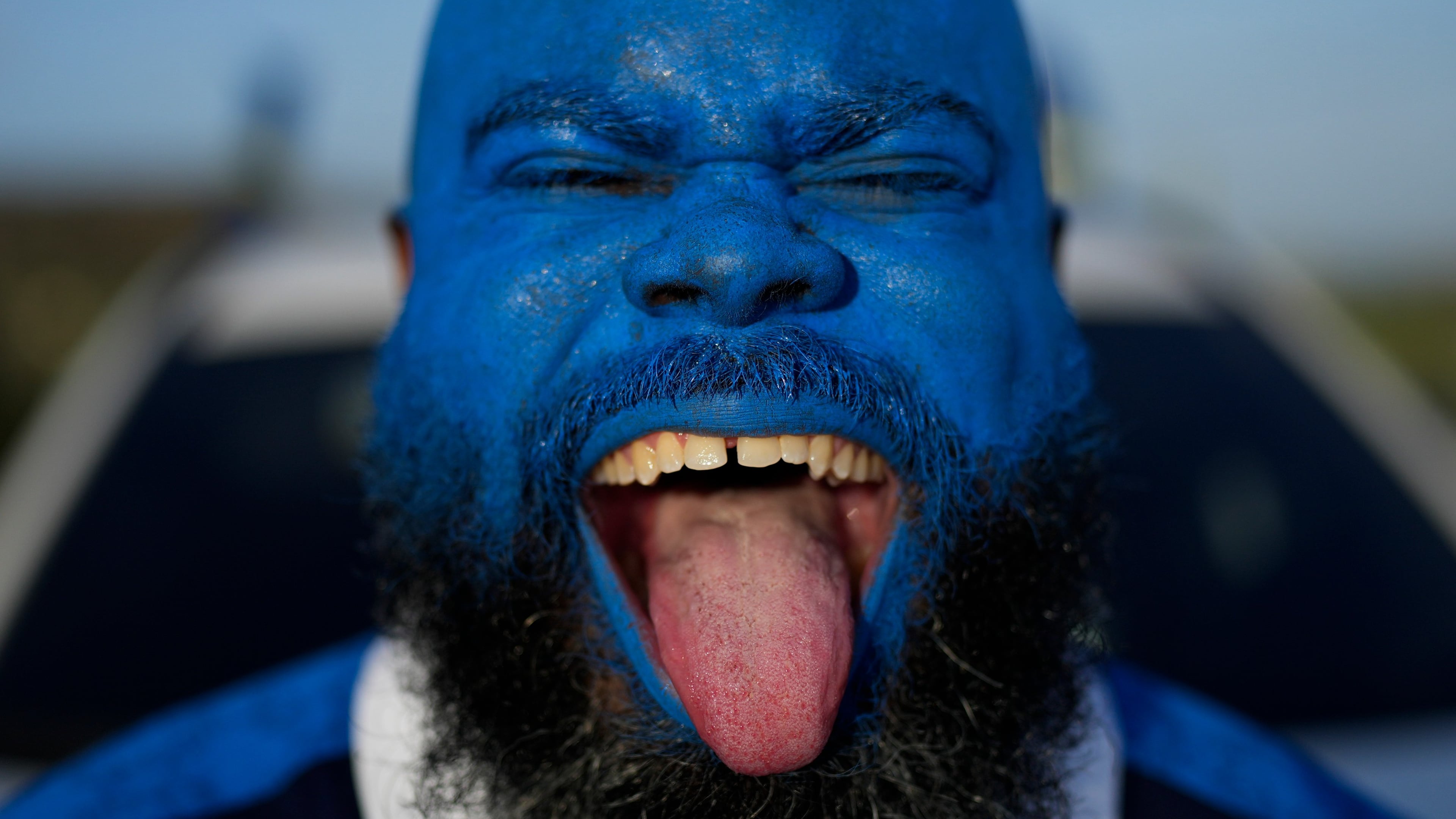 Brenton Balentien, known as Blue Face, a leader of supporters of Curacao’s national soccer team, poses wearing face paint in the team’s colors in Willemstad, Curacao, Saturday, May 16, 2026. (AP Photo/Matias Delacroix)