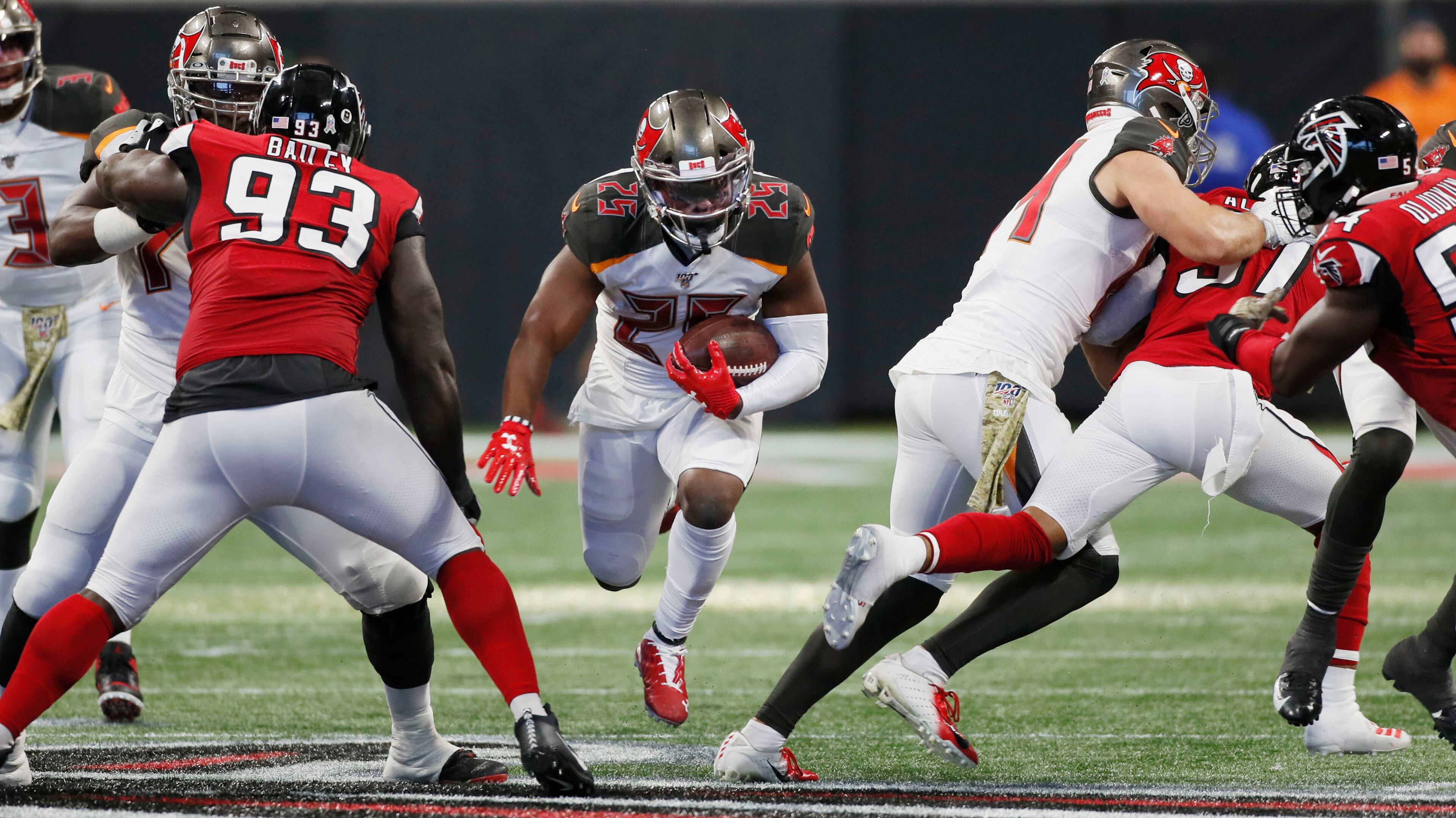Buccaneers running back Peyton Barber runs for a first down against the Falcons during the second half Sunday, Nov. 24, 2019, at Mercedes-Benz Stadium in Atlanta.