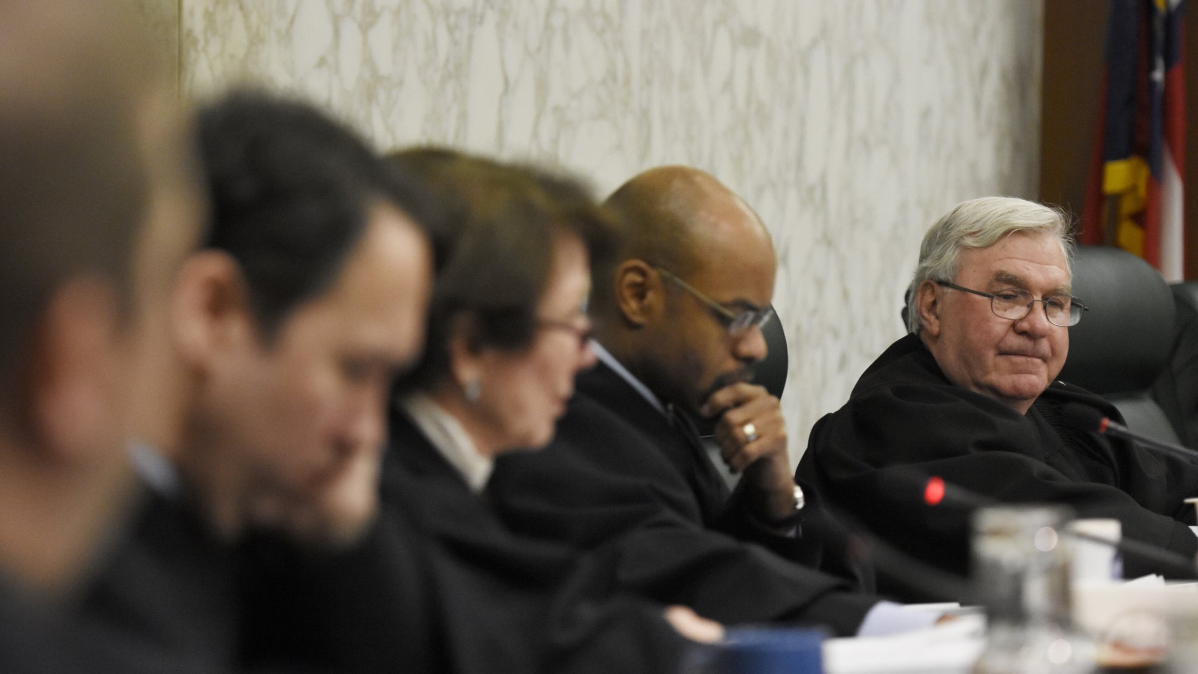 Chief Justice Harris Hines and other justices listen during oral arguments. Hines was recently summoned for jury duty in Cobb County.