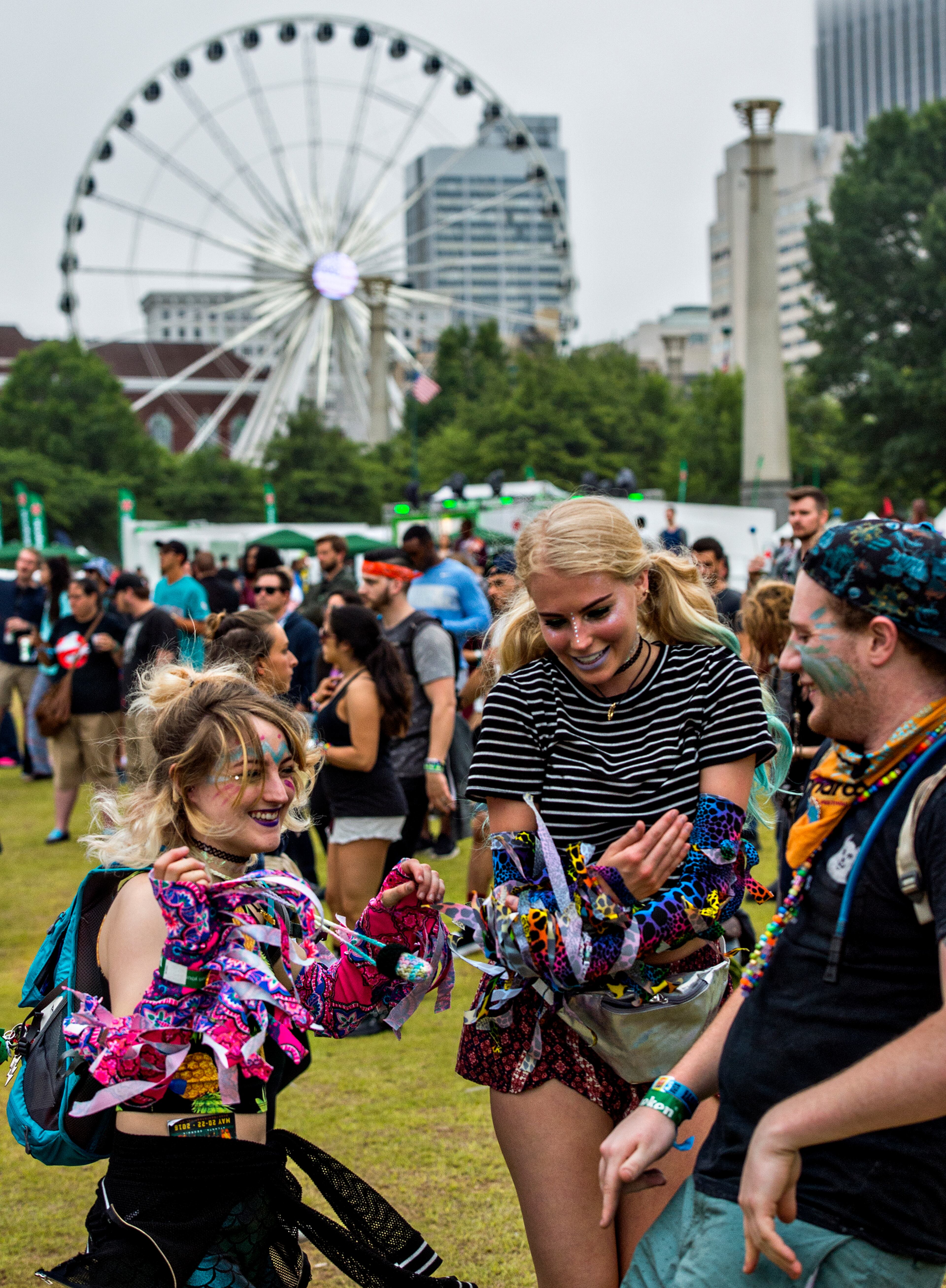 Kaitlyn Whalen (left), Becky Rasmussen and Tyler Adkins dance during the first night of the Shaky Beats Music Festival at Centennial Olympic Park in Atlanta on Friday, May 20, 2016. JONATHAN PHILLIPS / SPECIAL