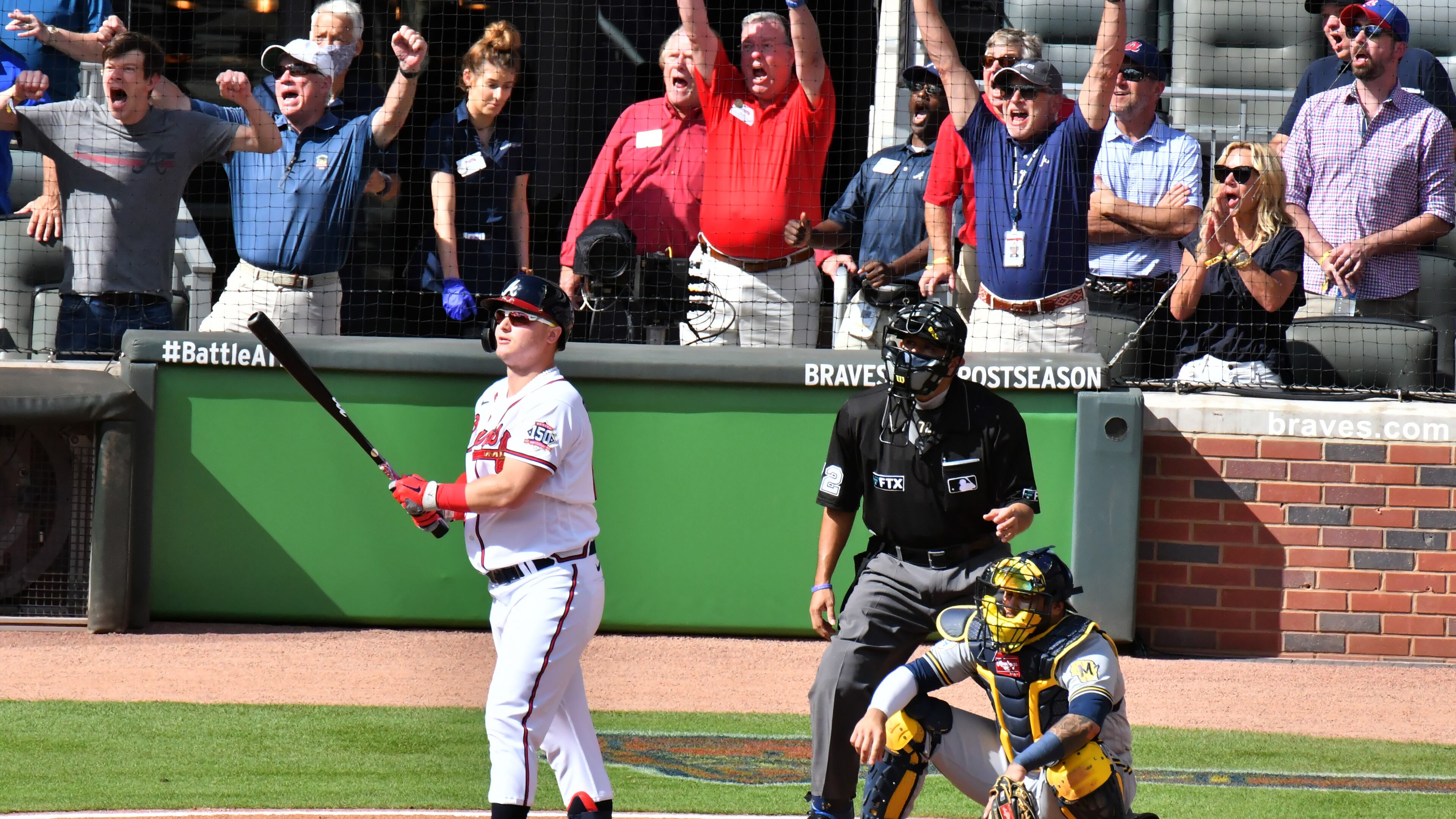 Happy times at Truist Park: Fans react as Joc Pederson follows through on his three-run pinch hit home run that provided all of the scoring in Monday's 3-0 victory over the Brewers.