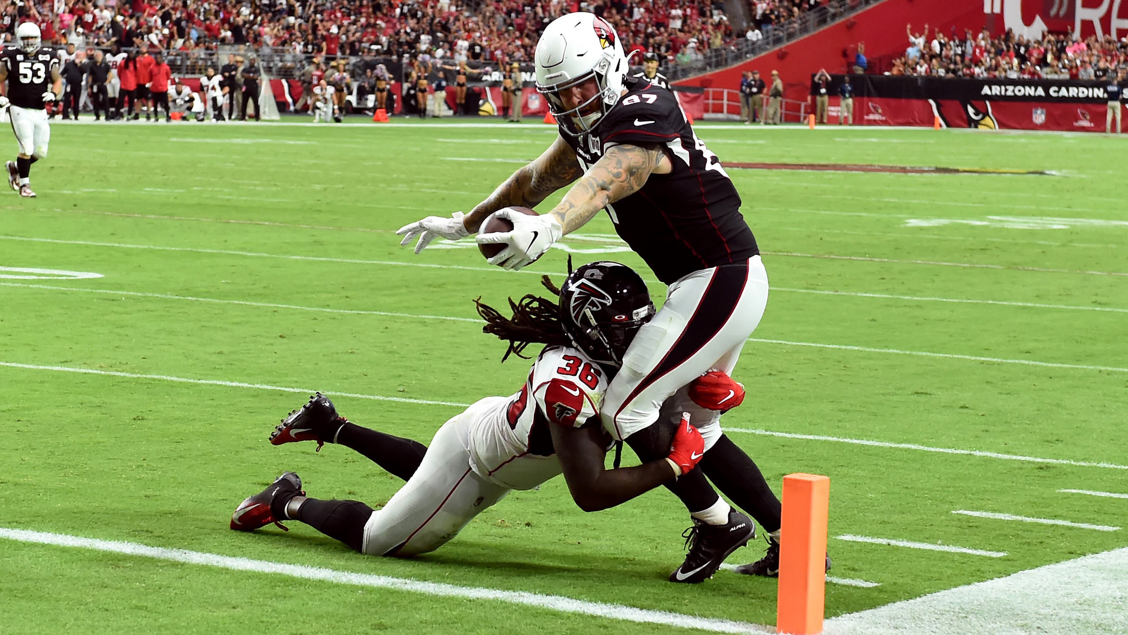Cardinals' Maxx Williams stretches the ball over the goal line for a touchdown while being tackled by the Falcons' Kemal Ishmael during the second half Oct. 13, 2019, at State Farm Stadium in Glendale, Ariz.