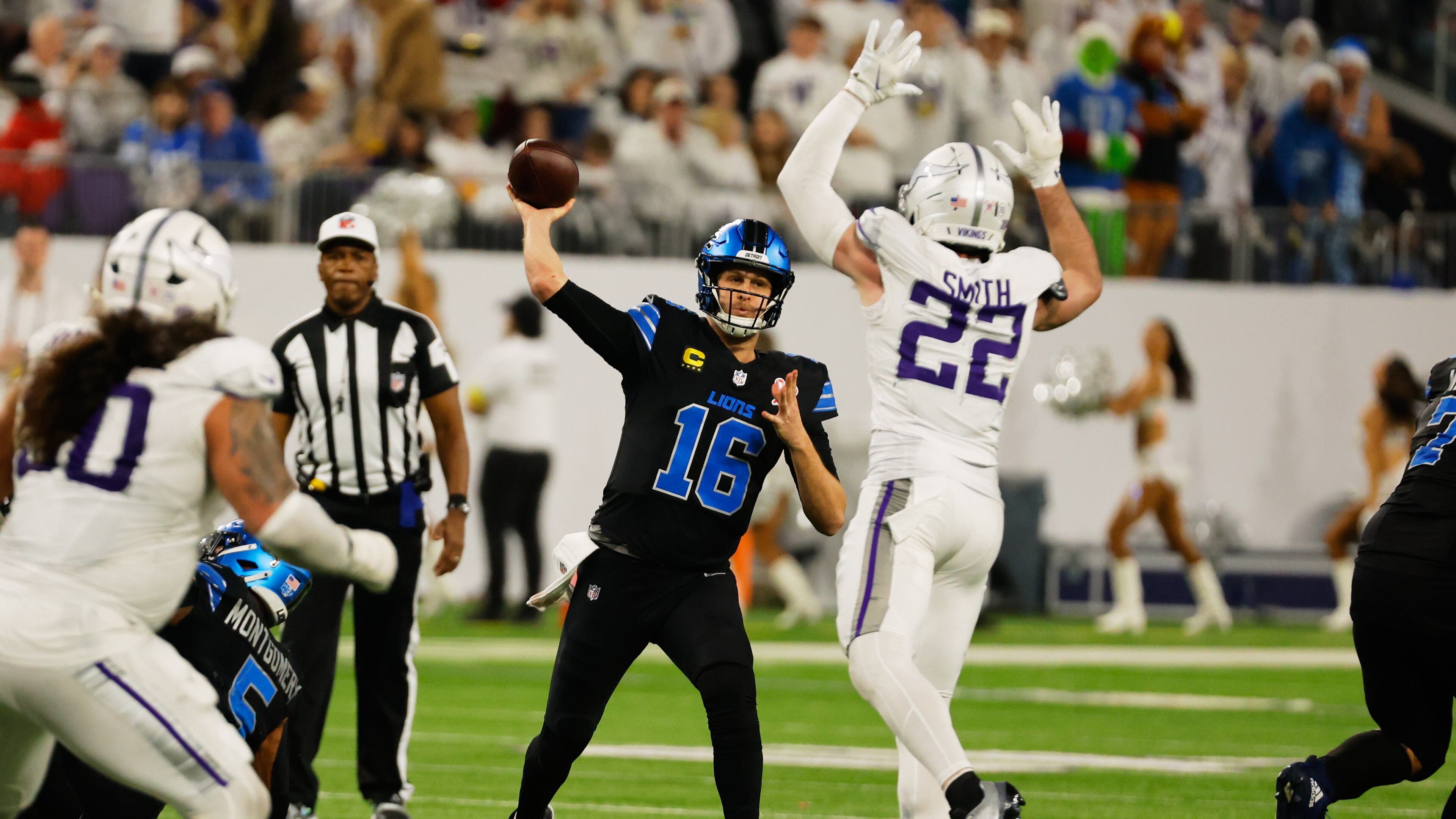 Detroit Lions quarterback Jared Goff (16) throws under pressure from Minnesota Vikings safety Harrison Smith (22) during the second half of an NFL football game, Thursday, Dec. 25, 2025, in Minneapolis. (AP Photo/Bruce Kluckhohn)
