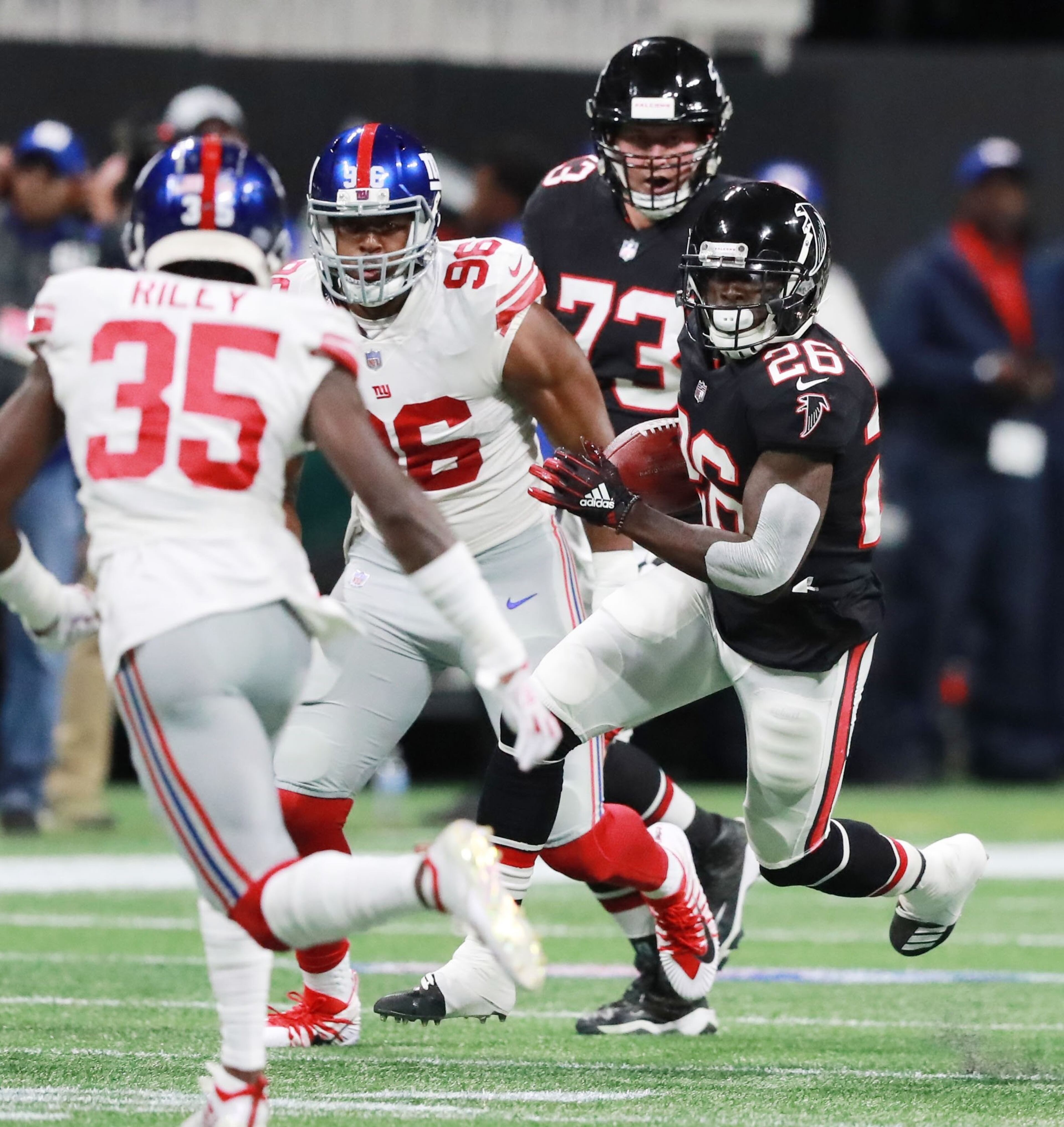 10/22/18 - Atlanta - Atlanta Falcons running back Tevin Coleman (26) runs for a first down on the opening drive of the Falcons. The Atlanta Falcons played the New York Giants in an NFL football game Monday, October 22, 2018, at Mercedes-Benz Stadium in Atlanta, GA. CURTIS COMPTON / CCOMPTON@AJC.COM