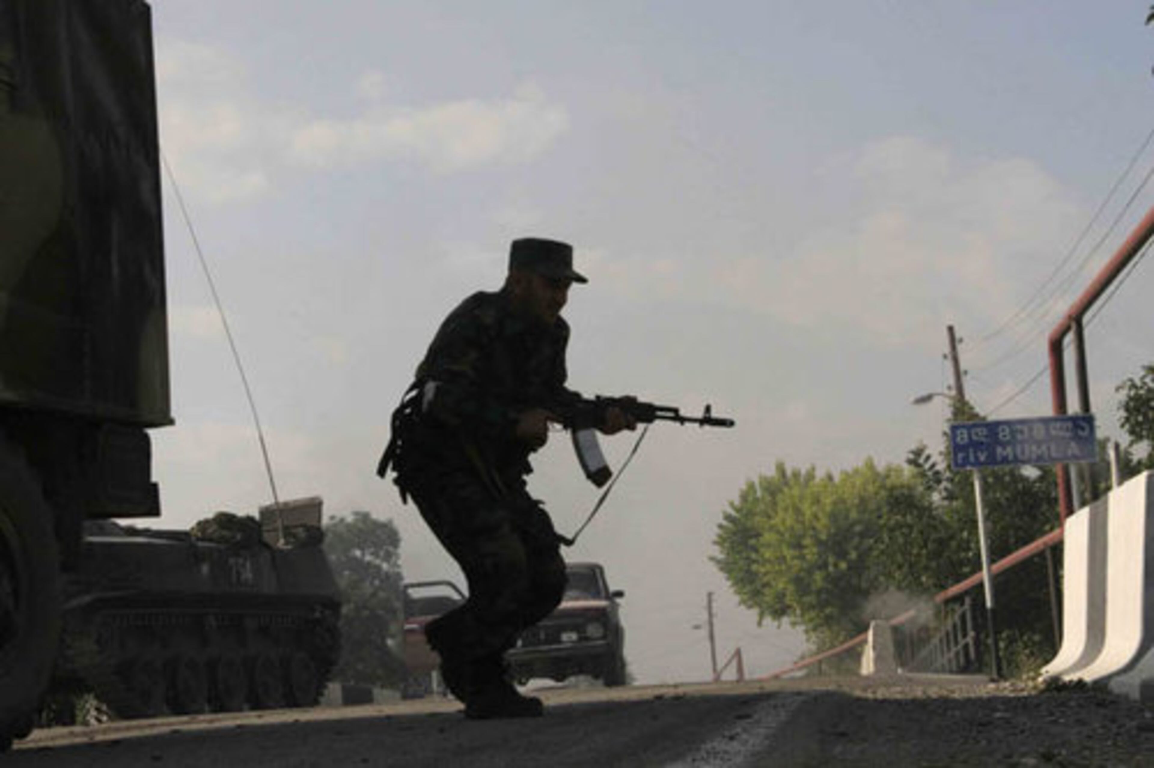 An Ossetian soldier runs for cover near the village of Achabet.