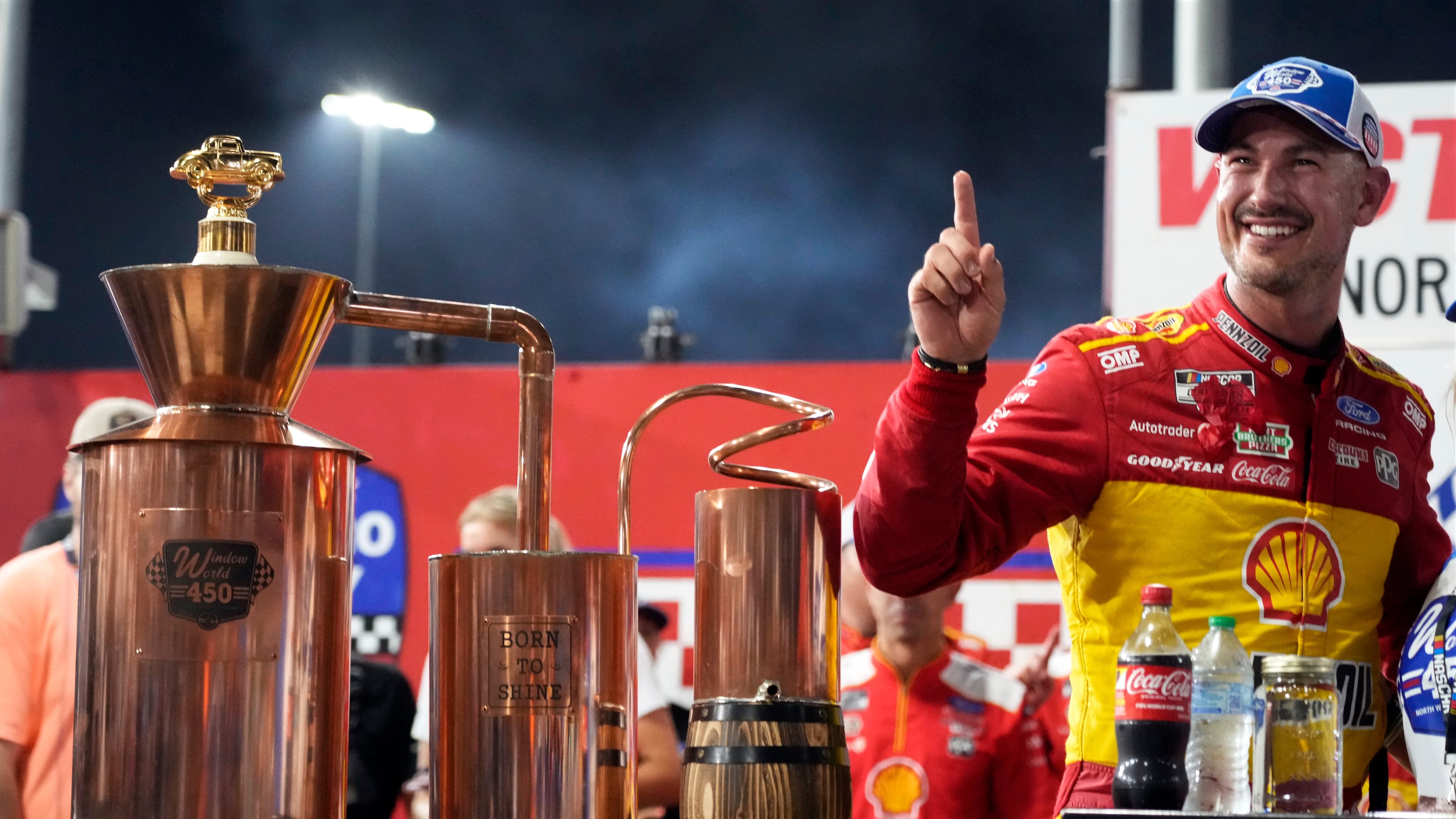 Joey Logano poses with the trophy in Victory Lane after winning a NASCAR Cup Series auto race in North Wilkesboro, N.C., Sunday, July 19, 2026. (AP Photo/Chuck Burton)