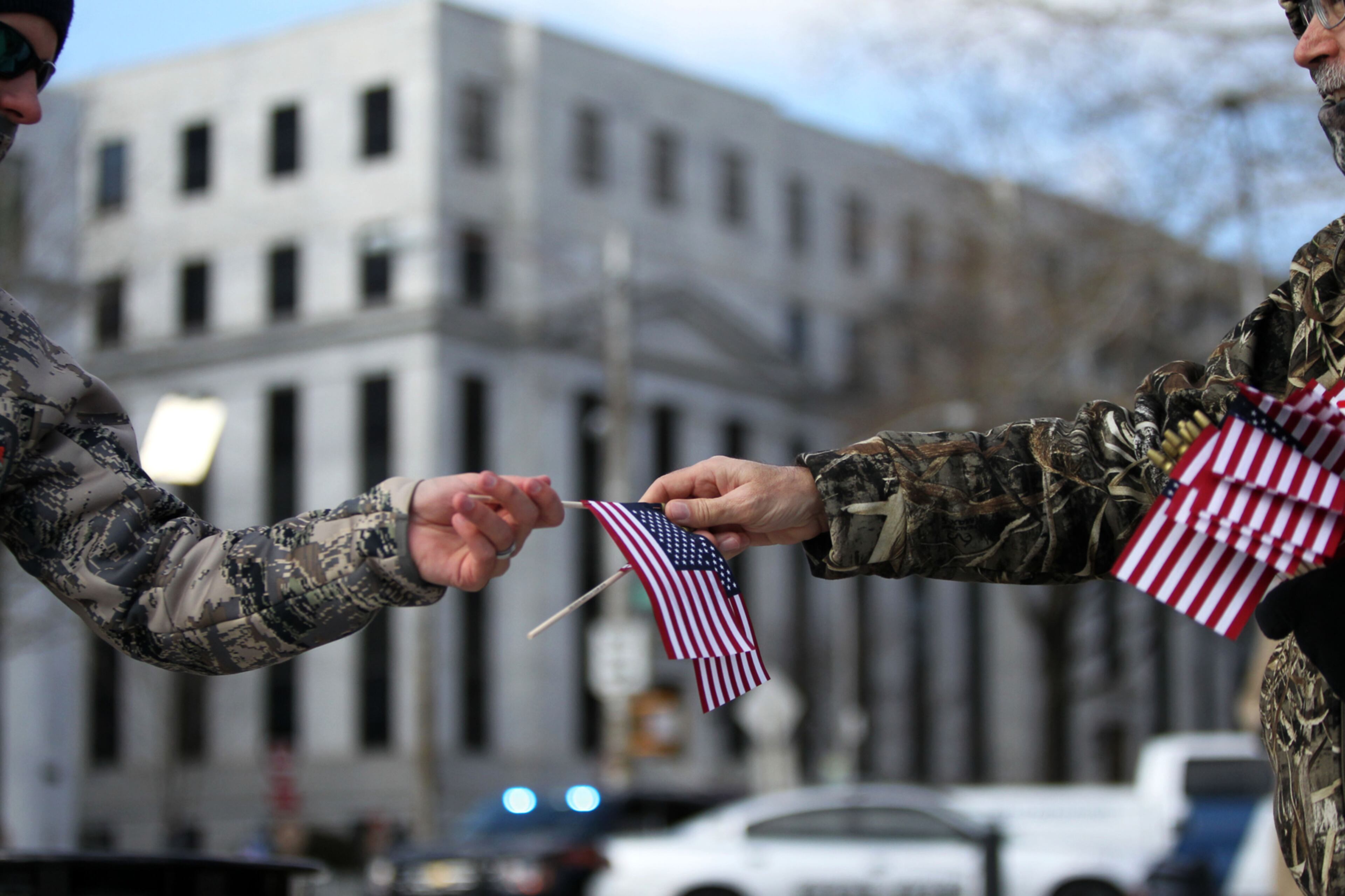February 10, 2016 Atlanta - A volunteer passes out American flags before Franklin Graham's prayer rally. The rally was part of Graham's Decision America Tour 2016. Graham said he had no faith in the democratic and republic parties. TAYLOR CARPENTER / TAYLOR.CARPENTER@AJC.COM